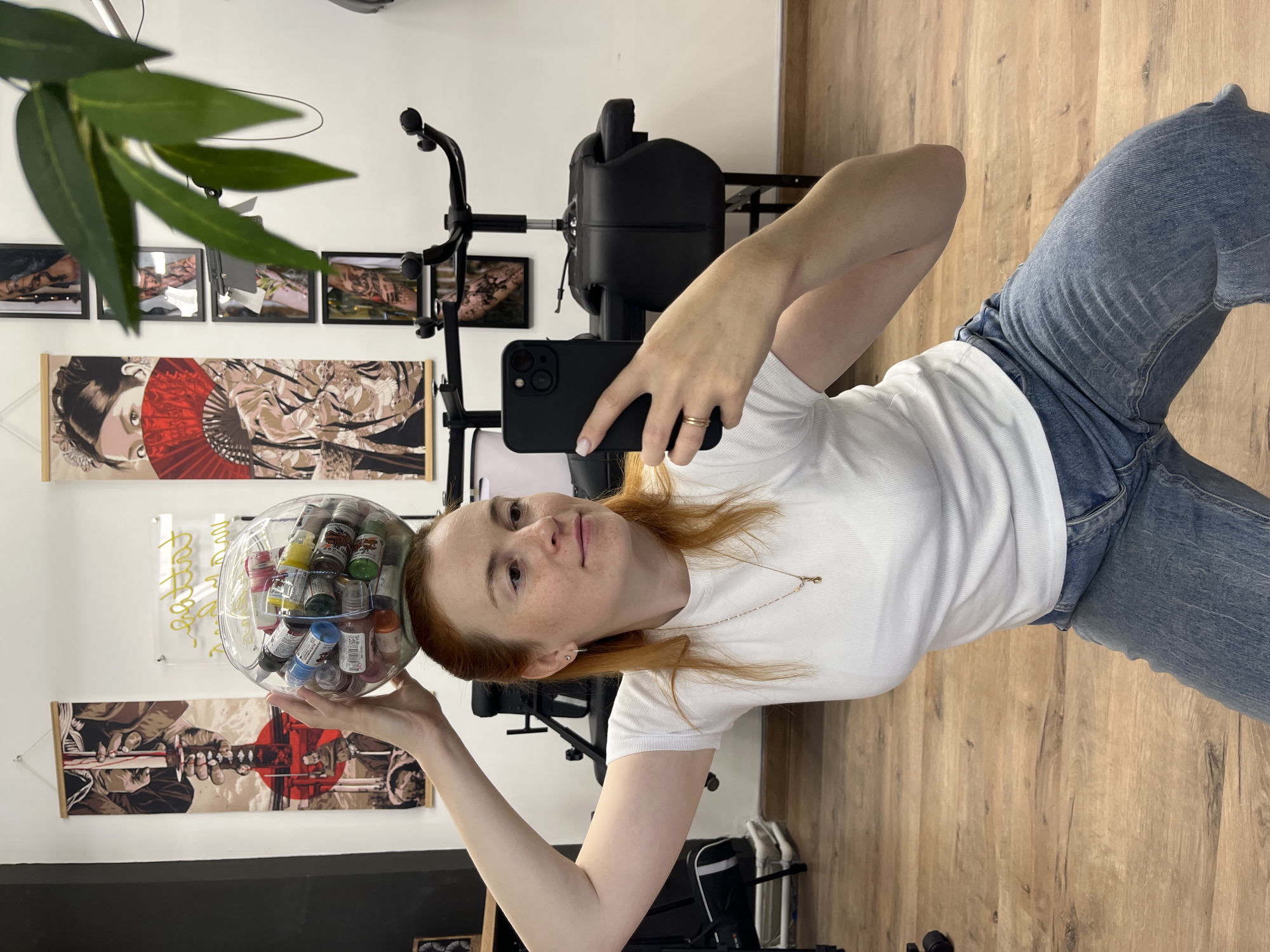 Mirror selfies in a Chaikovsky tattoo studio, ink bowl balanced on head