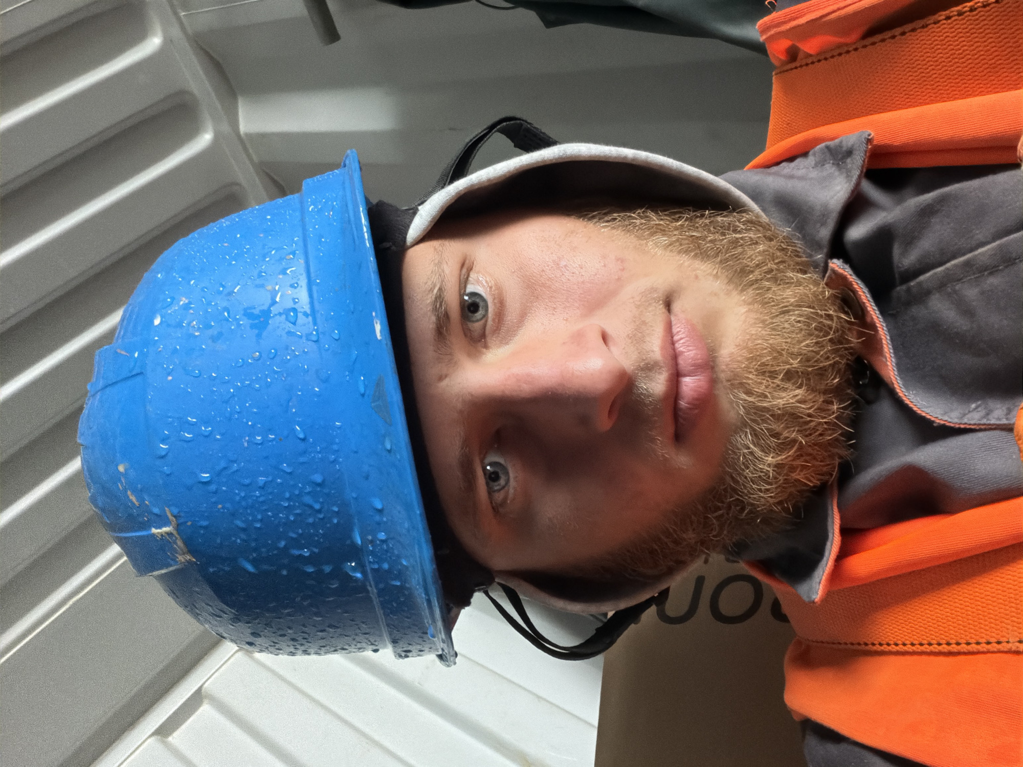 Wet hard hat and muddy boots at a Janowice work site
