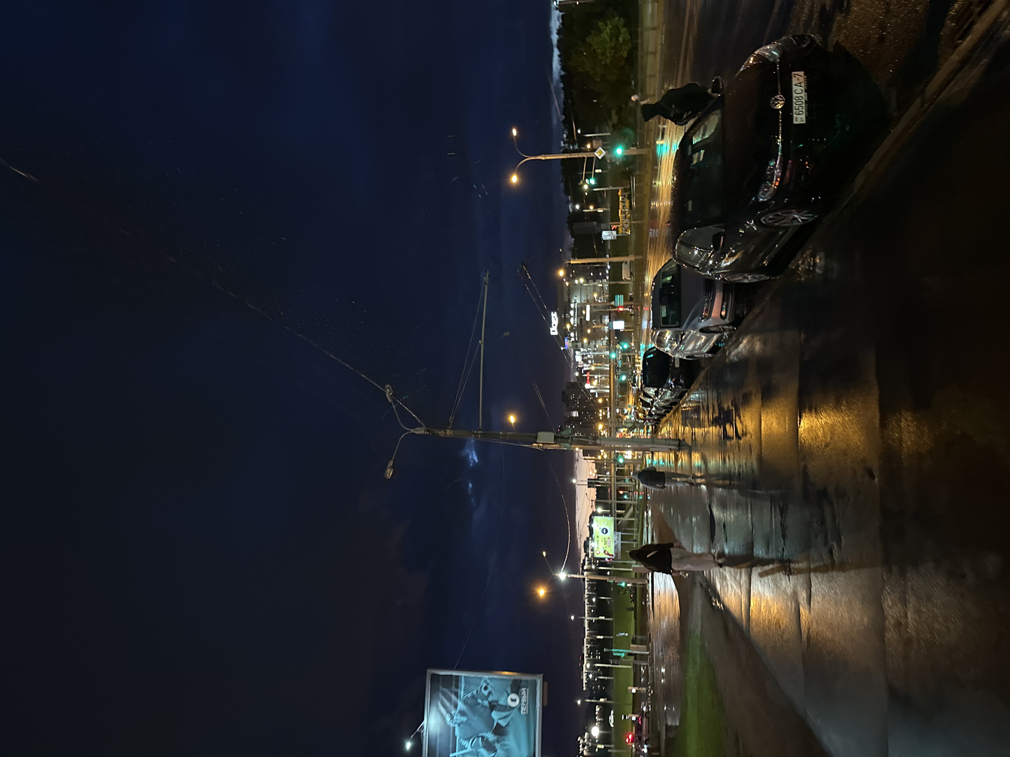 Rainy evening street life documented across central Minsk