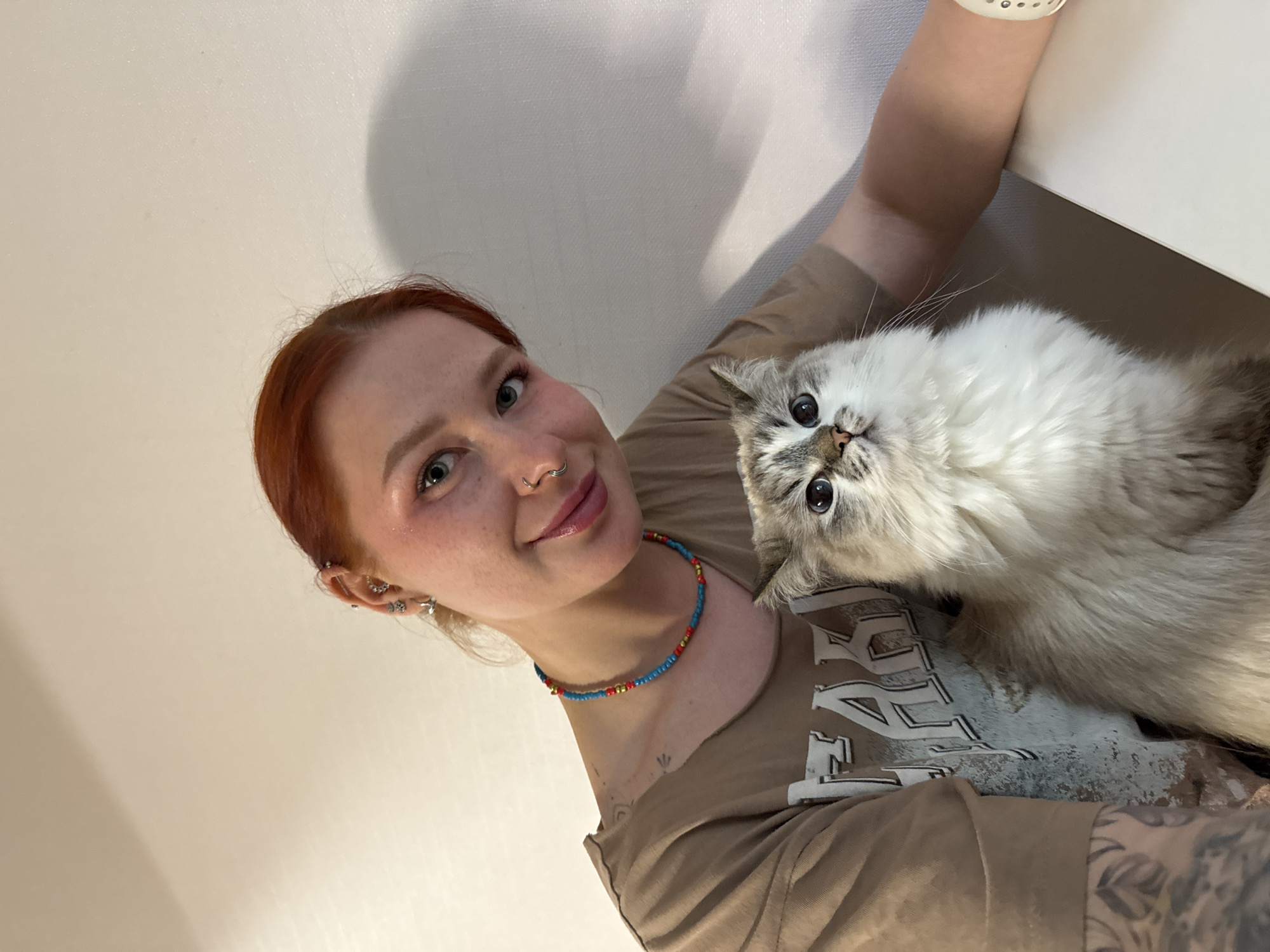 Woman photographs herself with cat, orchids in Rostov-on-Don
