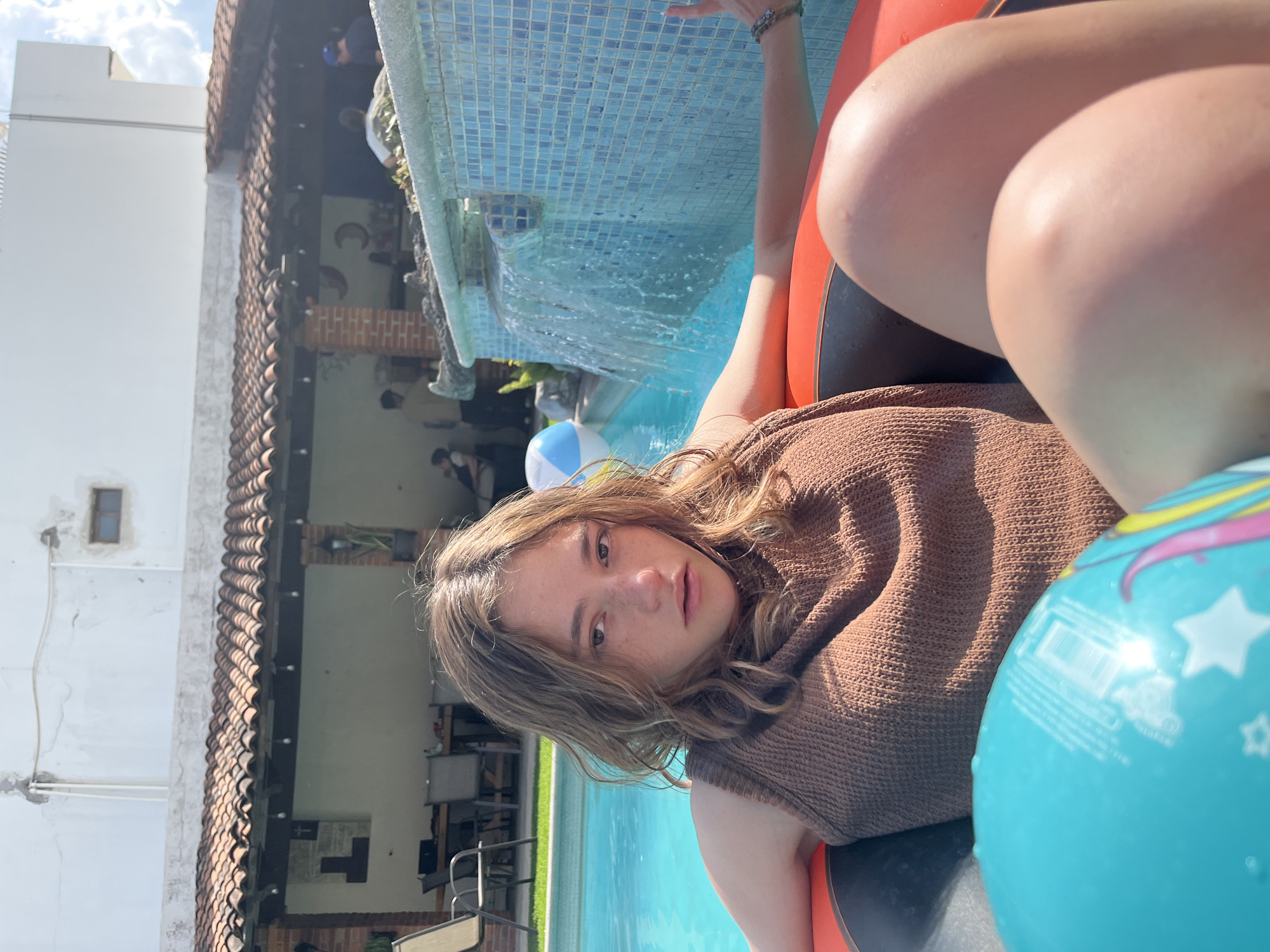Evening pool gathering features inflatable floats and fresh coconut