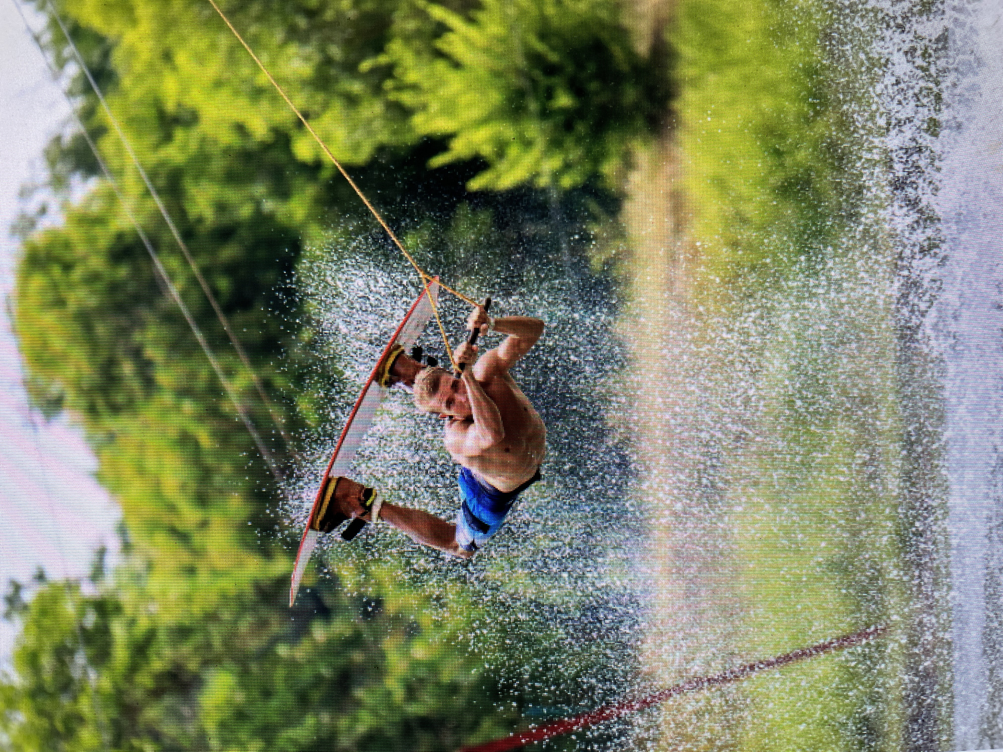 Wakeboarder performs aerial tricks on water in Bacong, Philippines