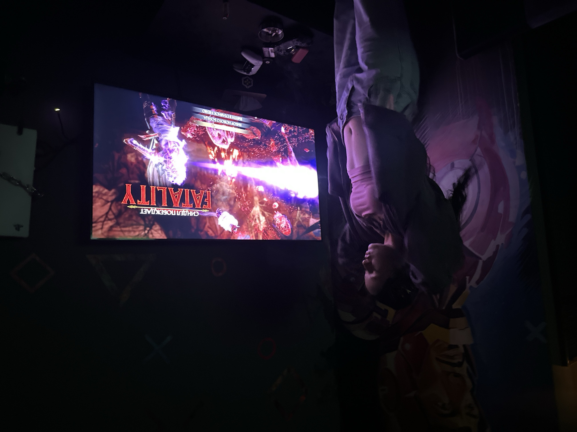 Person hangs upside down while playing Mortal Kombat in Yerevan