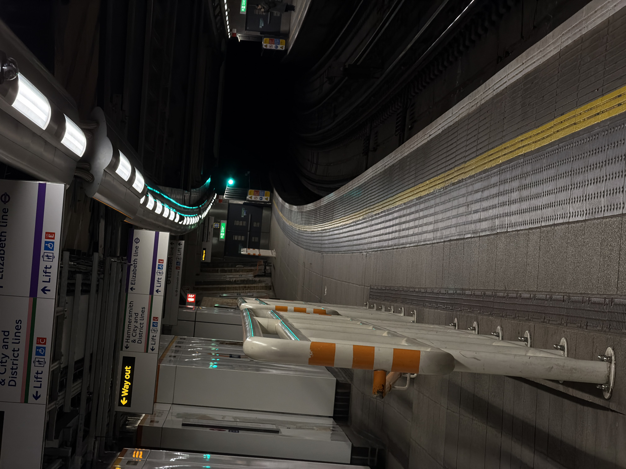 London Underground platform observed with curved fluorescent lighting