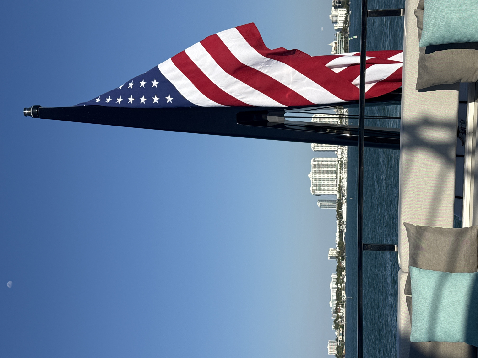 American flag waves from boat near Miami Beach skyline