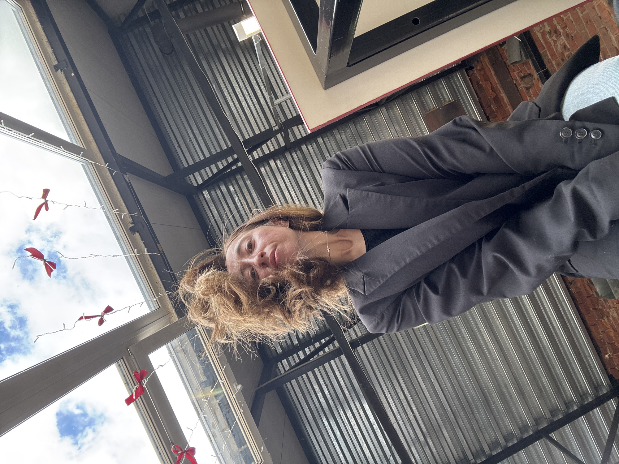 Woman photographed from low angles in Chaikovsky cafe interior