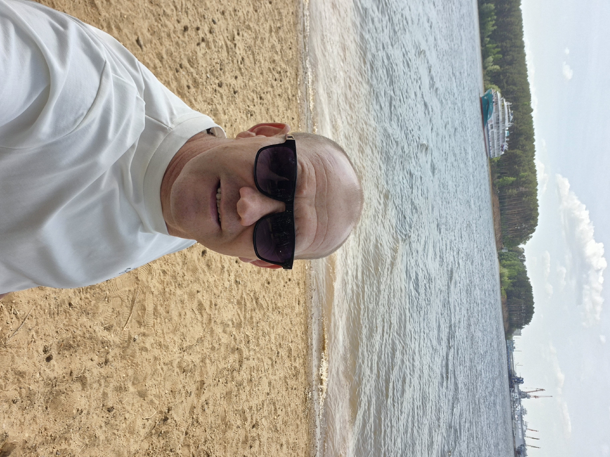 Man takes selfie on beach near Chaikovsky, Russia