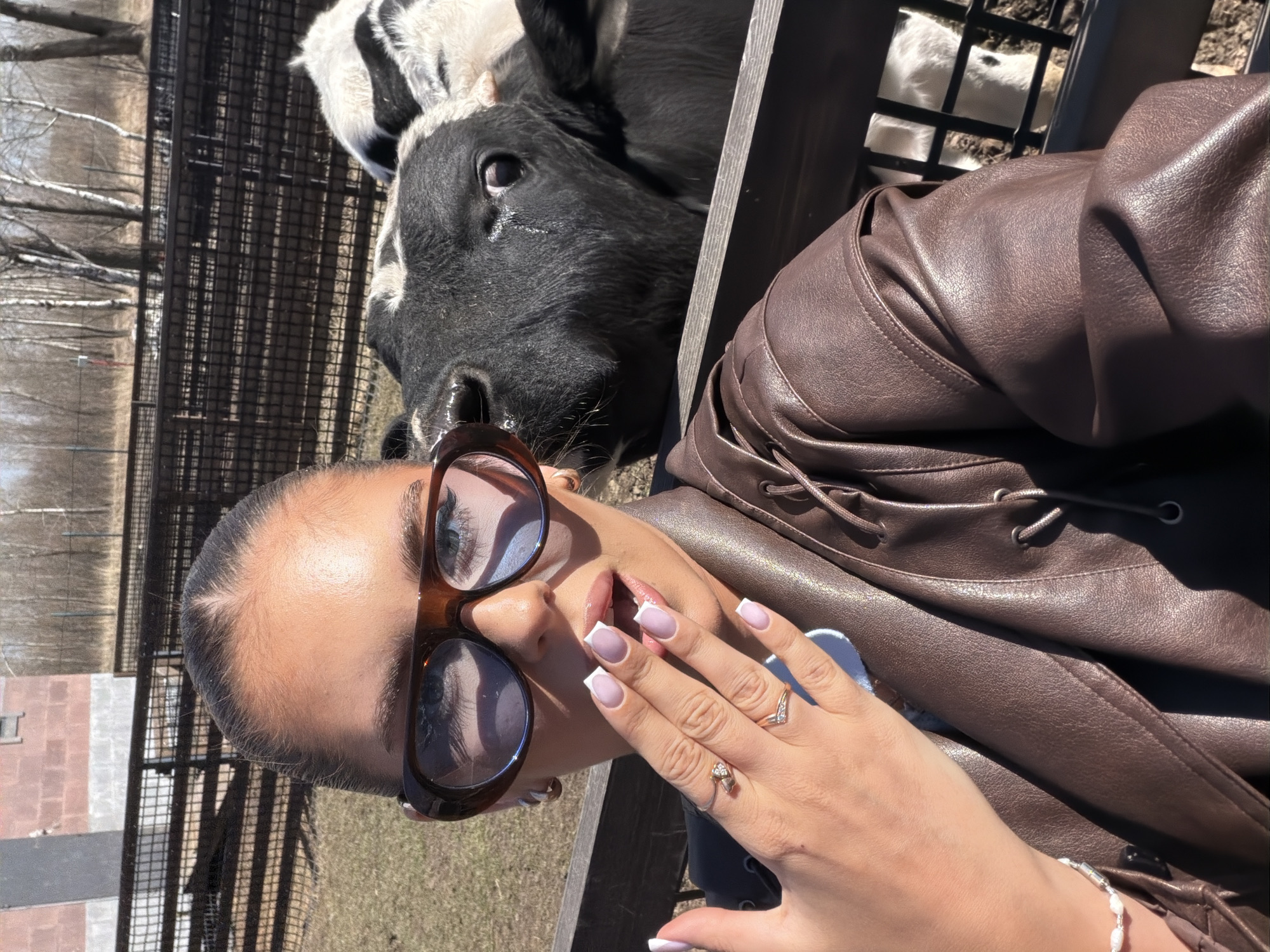 Woman poses with cow in sunny selfie in Berezovka
