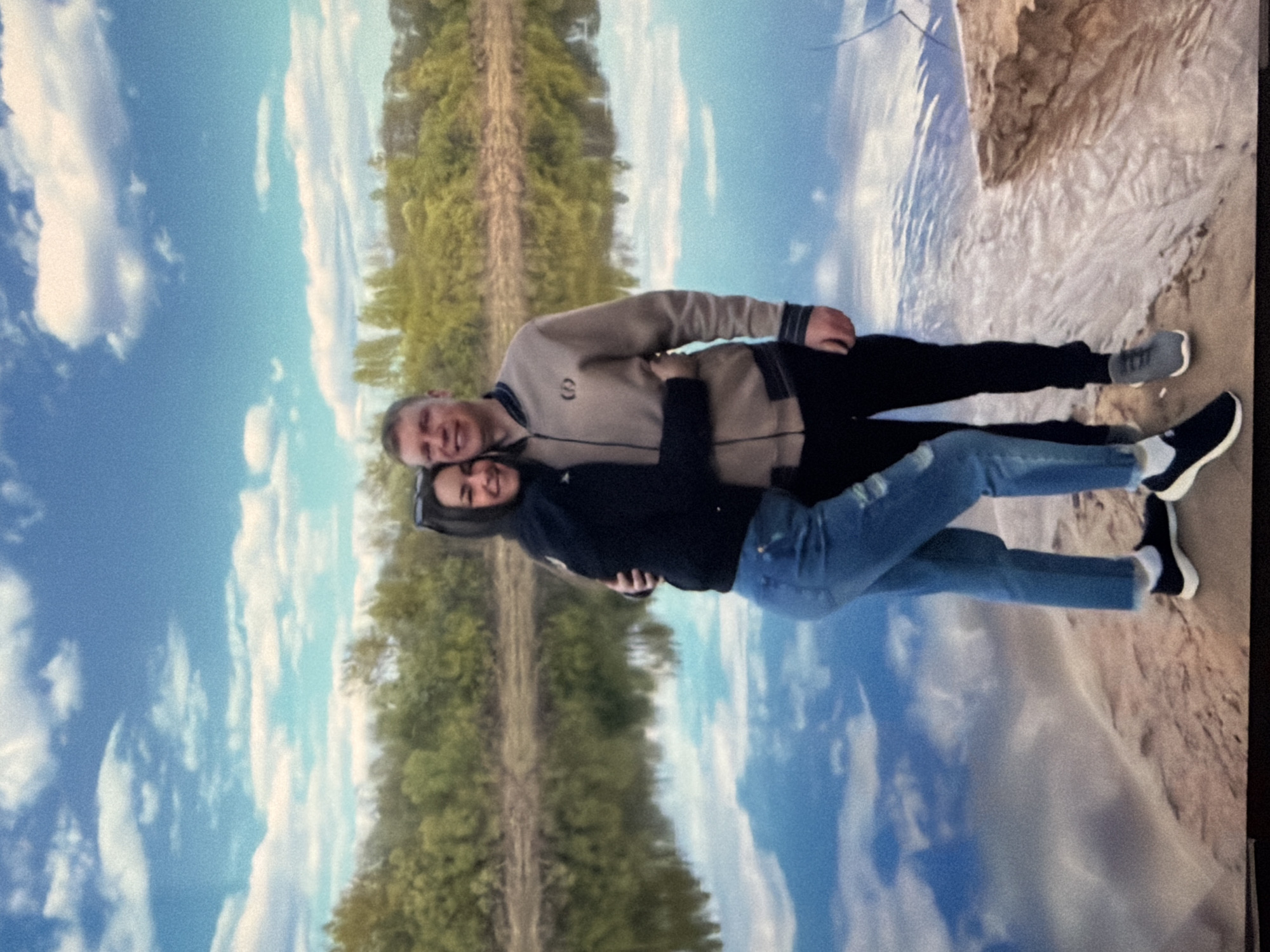 People pose for photos at coastal location