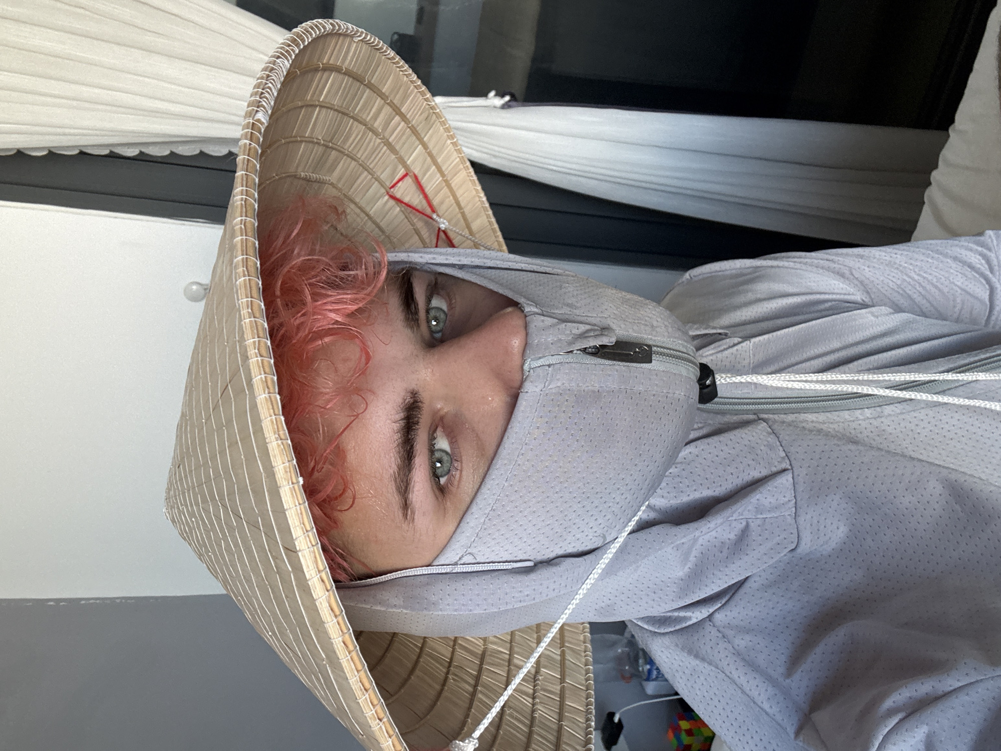 Pink-haired person photographed in Vietnamese conical hat in Đà Nẵng