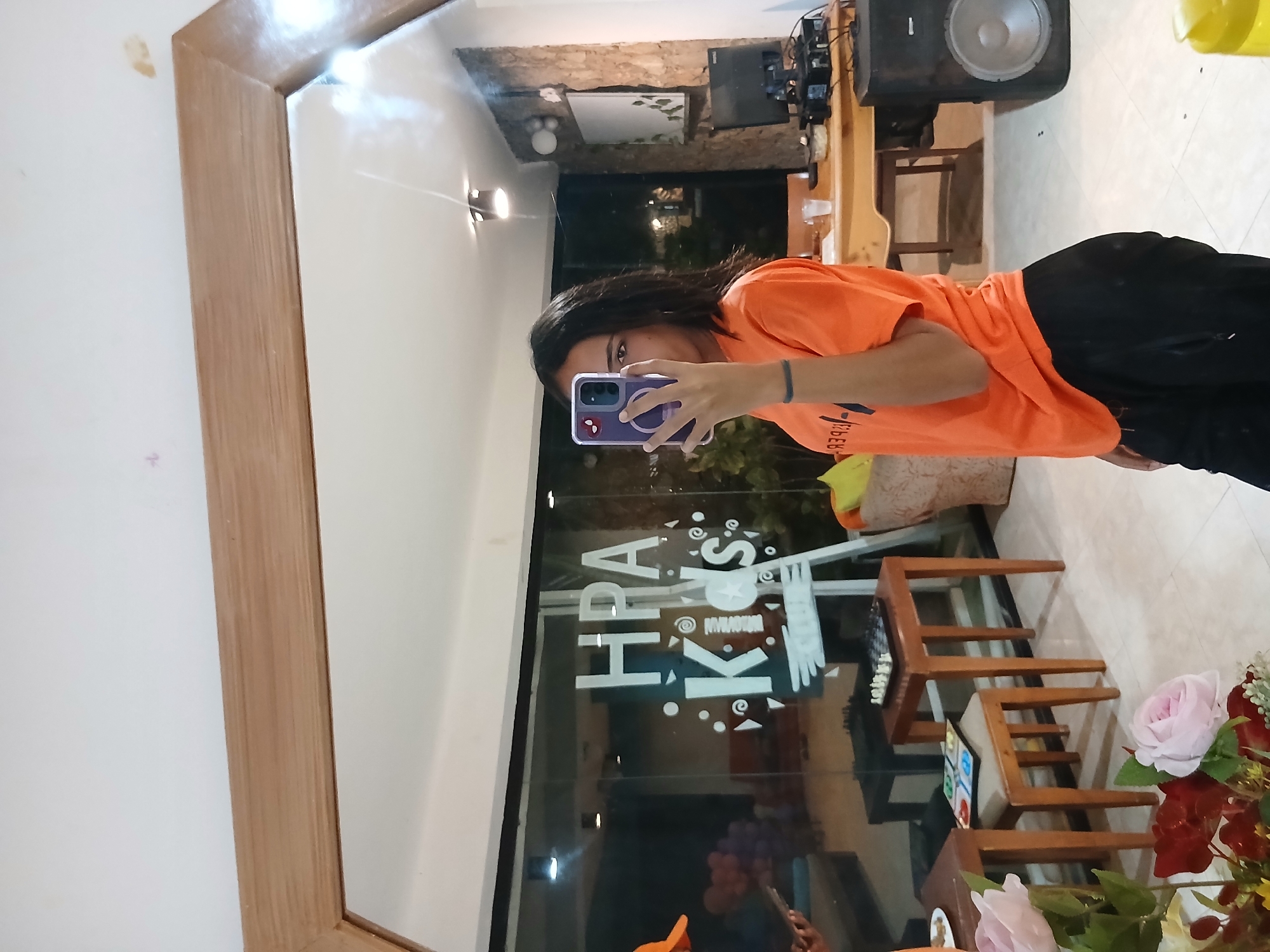 Person takes mirror selfies at Playa El Agua restaurant