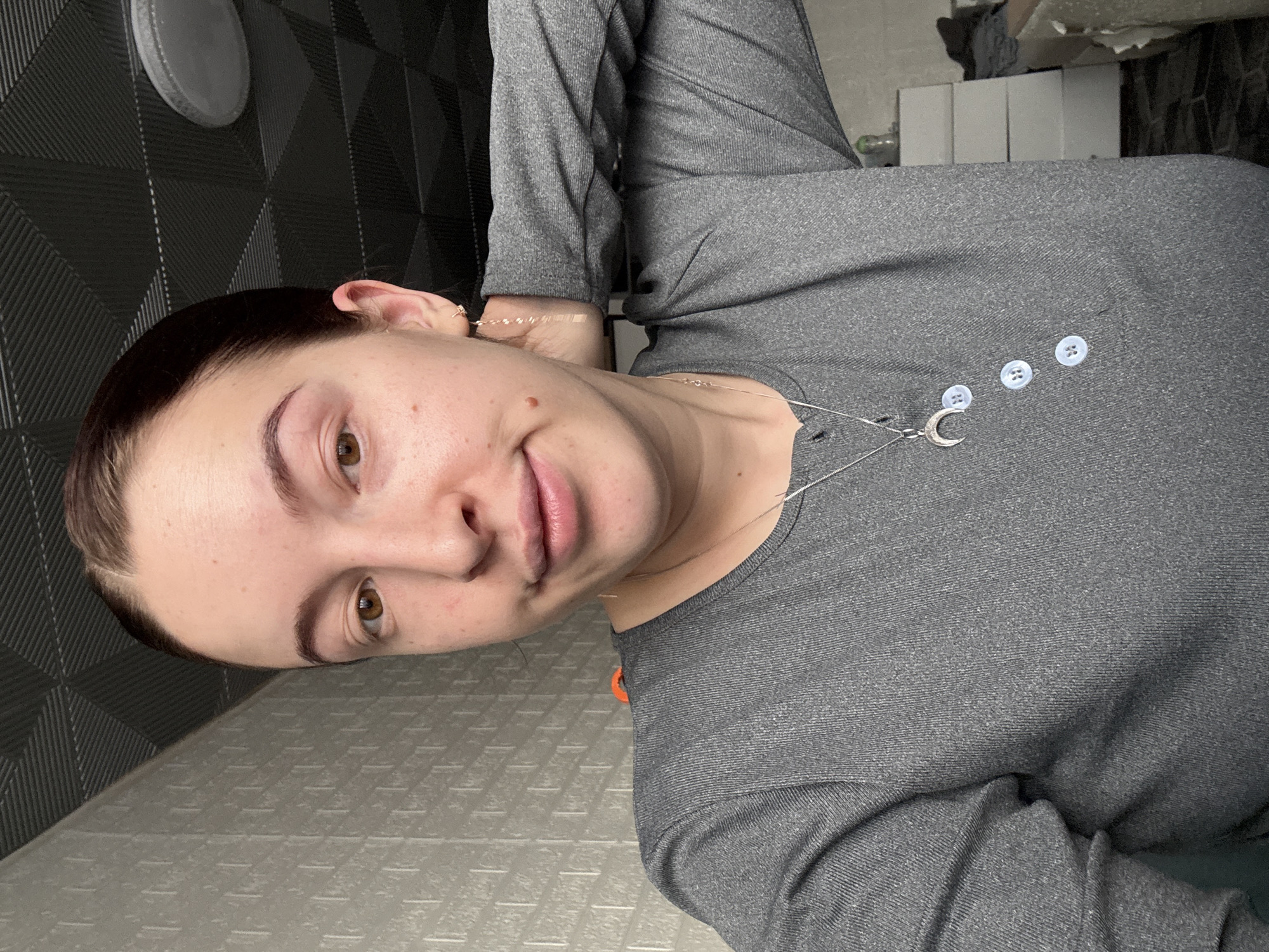 Woman photographed indoors in Donetsk wearing crescent moon necklace