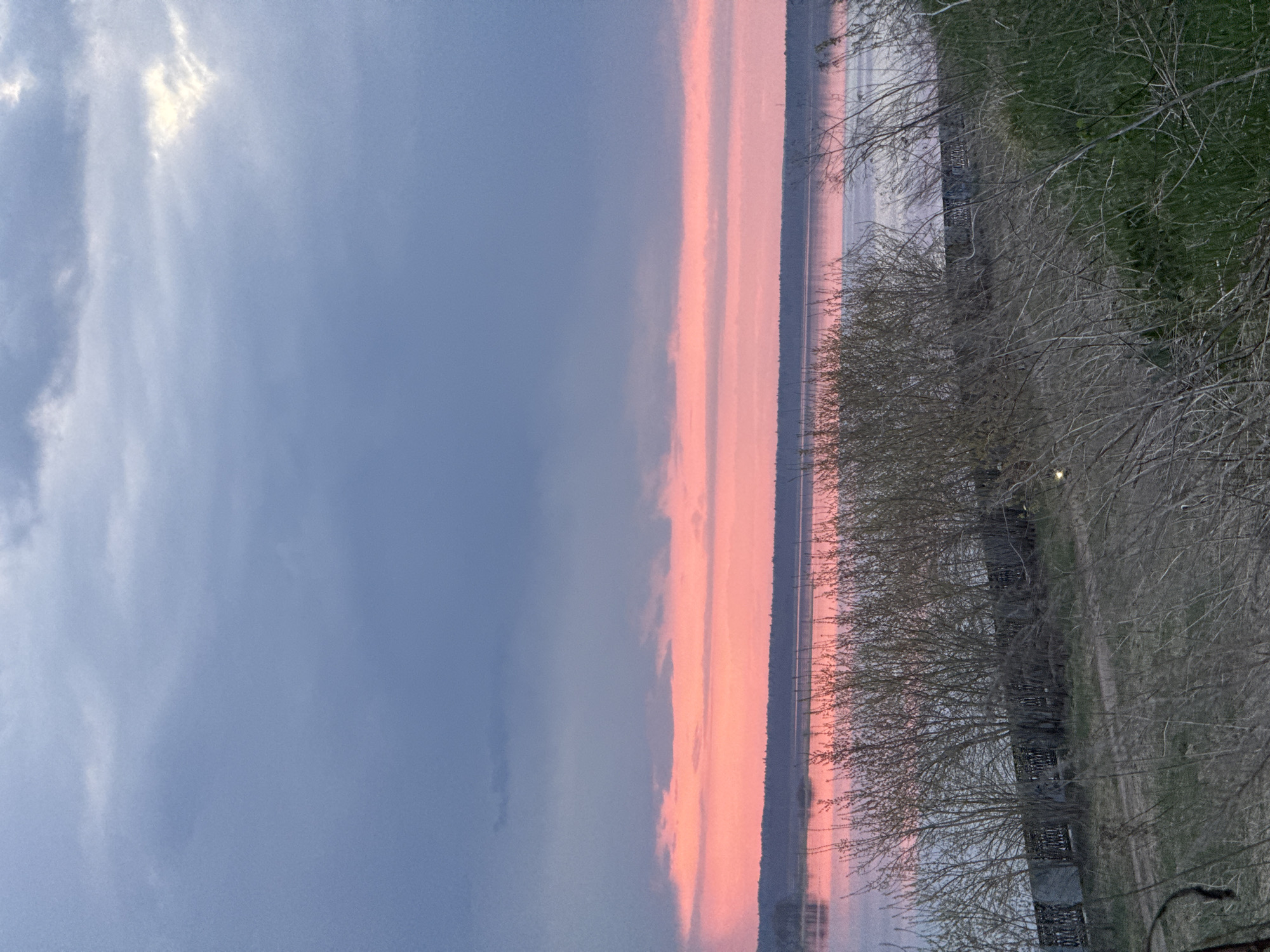 Sunset observed over lake in Izhevsk with pedestrians present