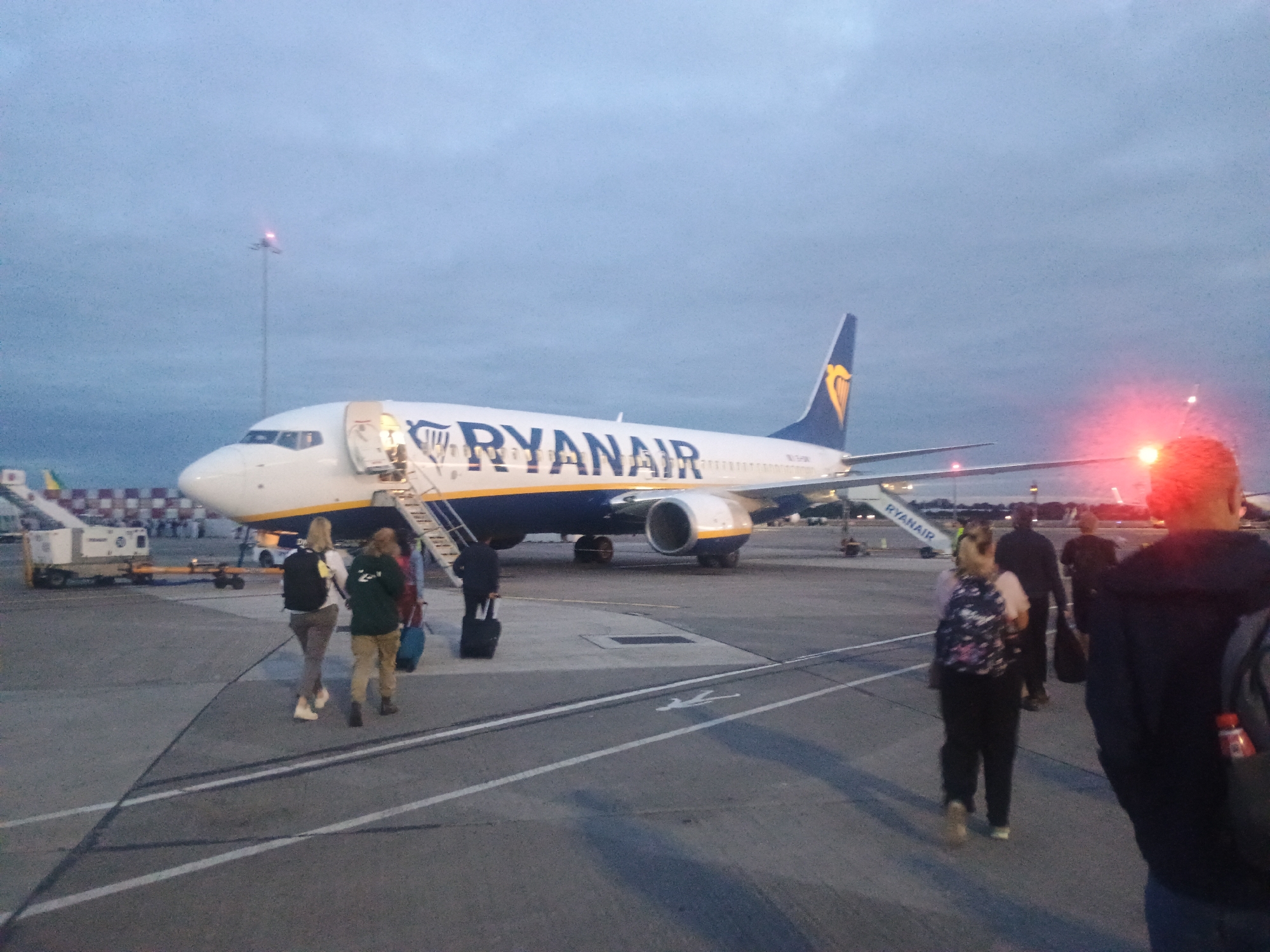 Ryanair fleet lines the tarmac at dusk
