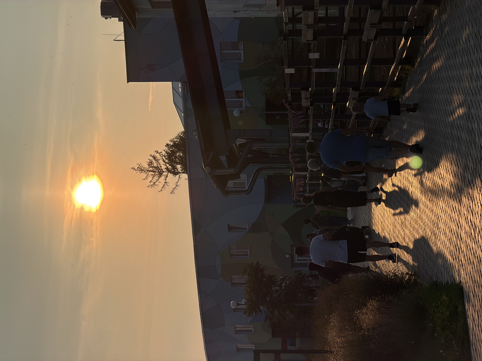 Golden hour on a Perm walkway, sun low and people out