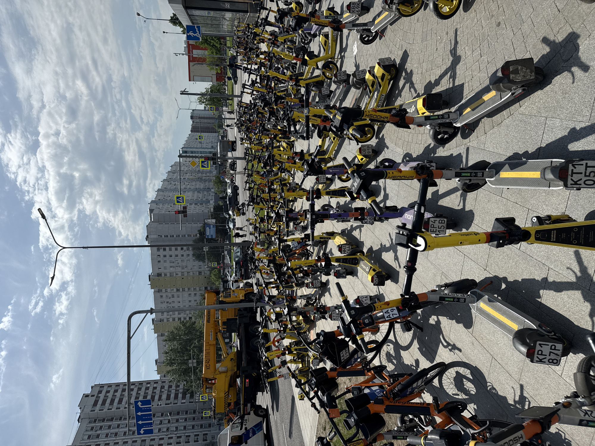 Rental scooters and bikes clustered in Moscow parking area