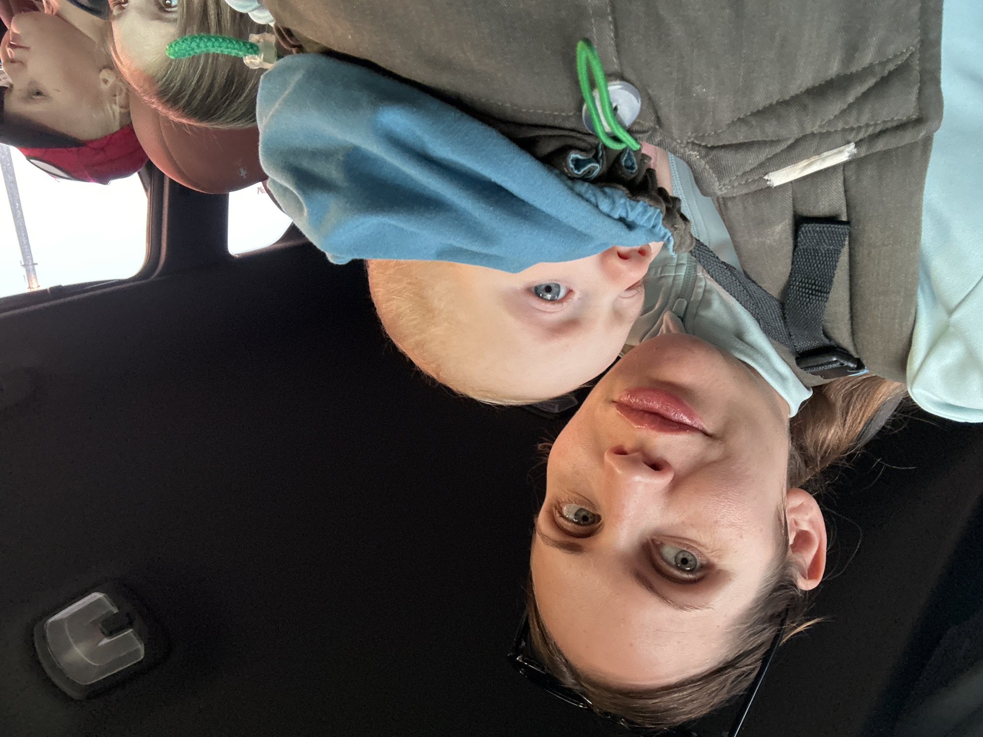 Woman takes selfie with child in carrier in Fethiye