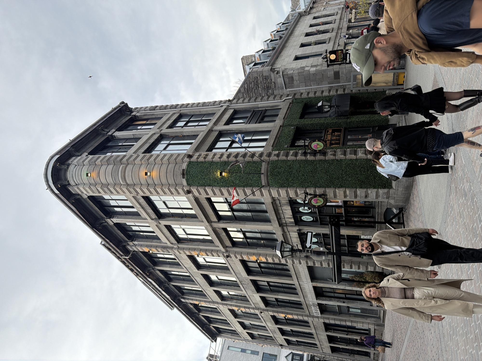 Stone building with greenery documented in Montreal street scene