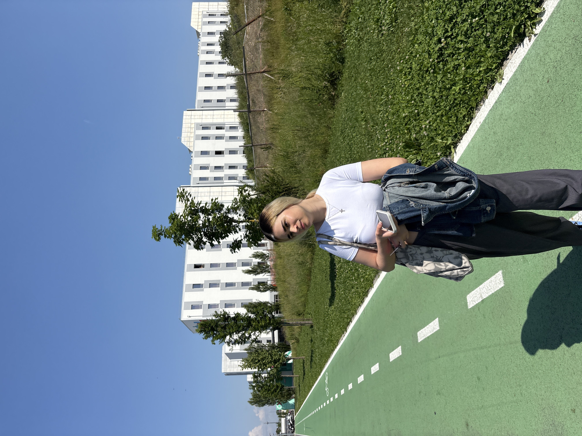 Woman stands on green path in Novate Milanese
