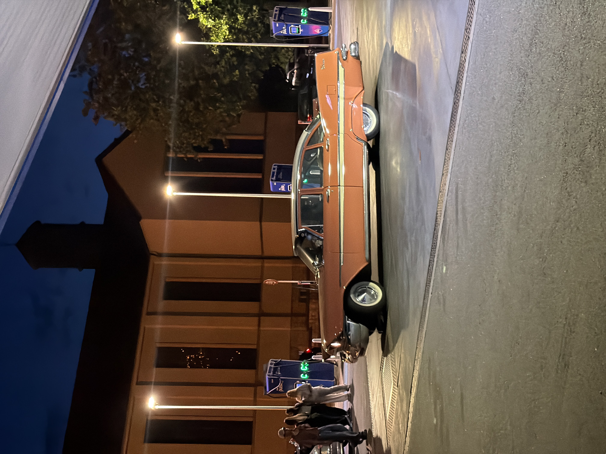 Classic pink Plymouth Fury parked on wet streets in Luxembourg