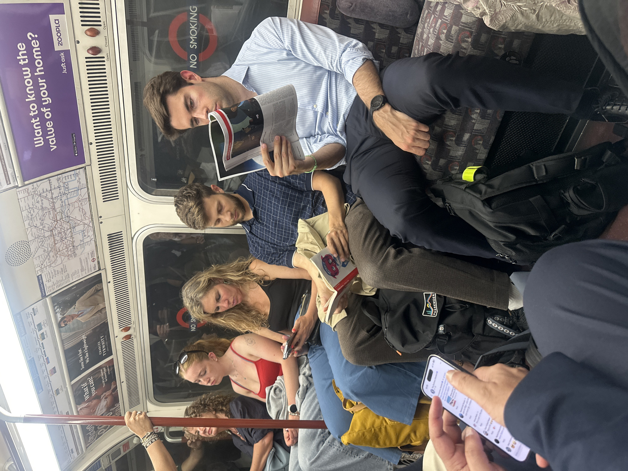 Passengers riding the London Underground on a quiet evening commute