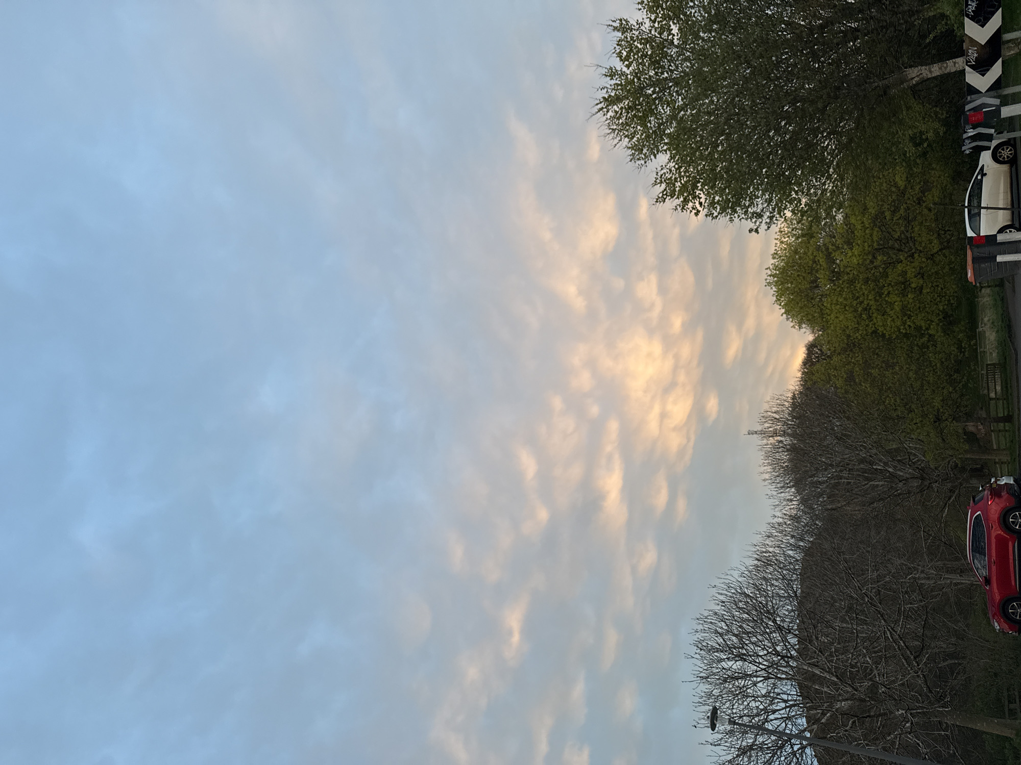 Evening traffic flows under sunset skies along highway