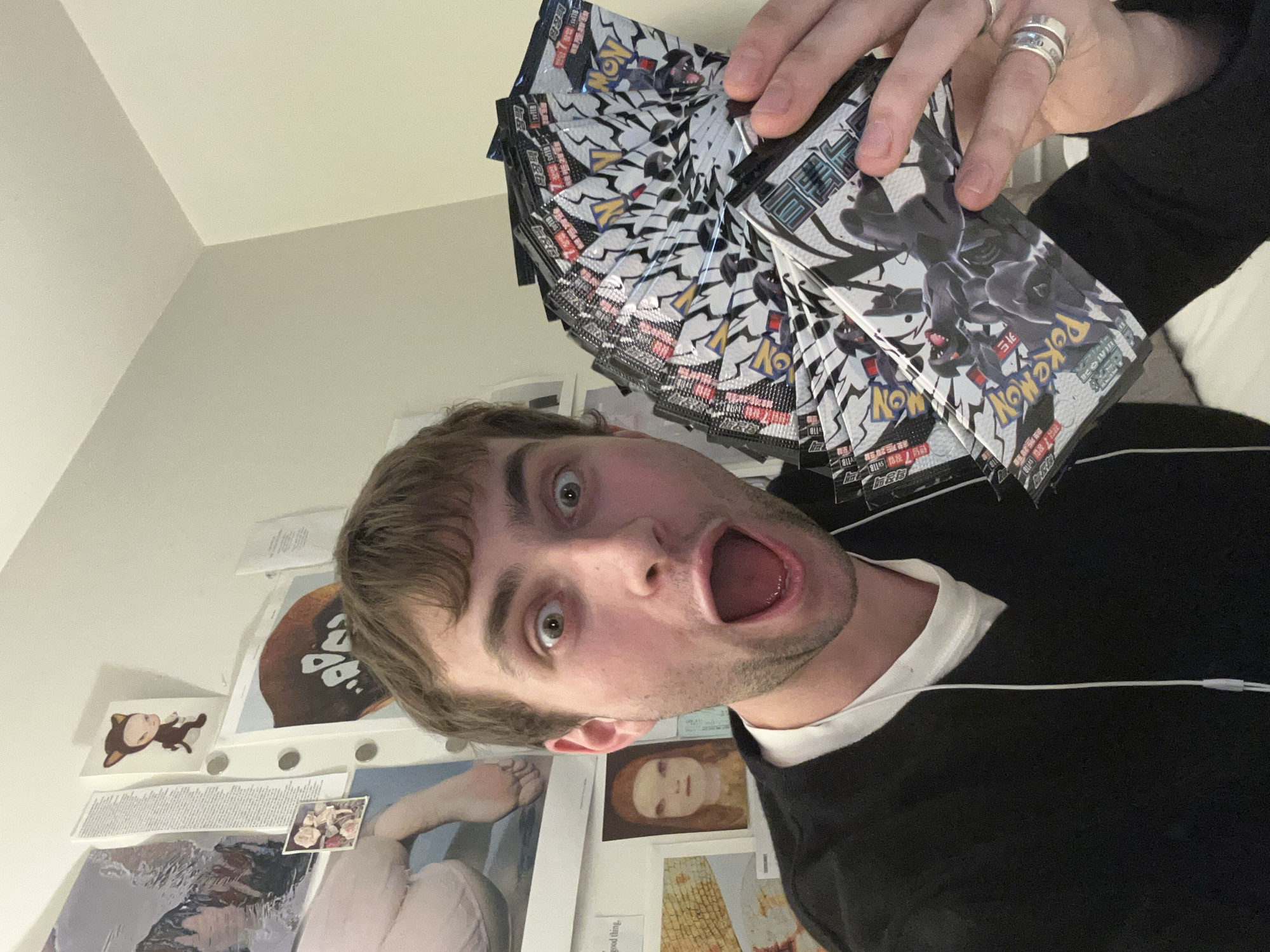London resident photographs self with Pokémon card packs