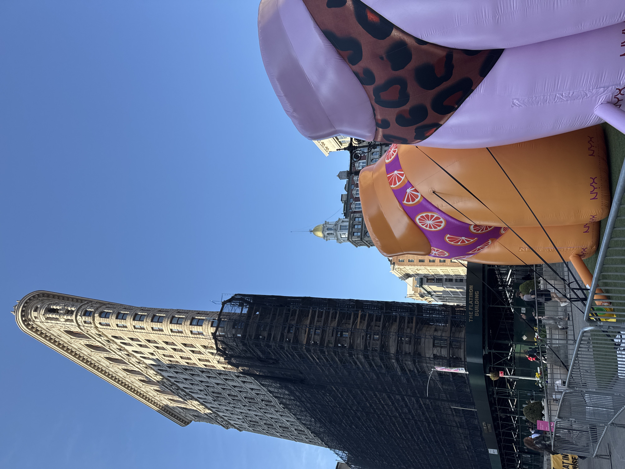 Flatiron Building under construction with inflatable displays nearby