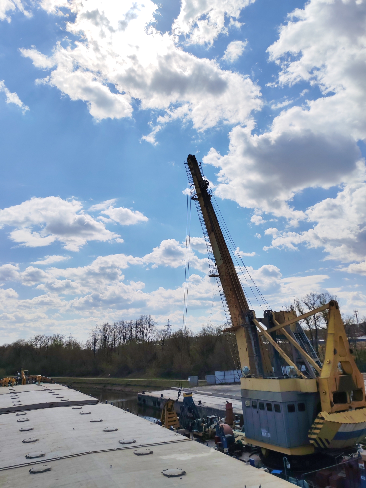 Industrial barge with cranes navigates Moscow Canal near Yakhroma