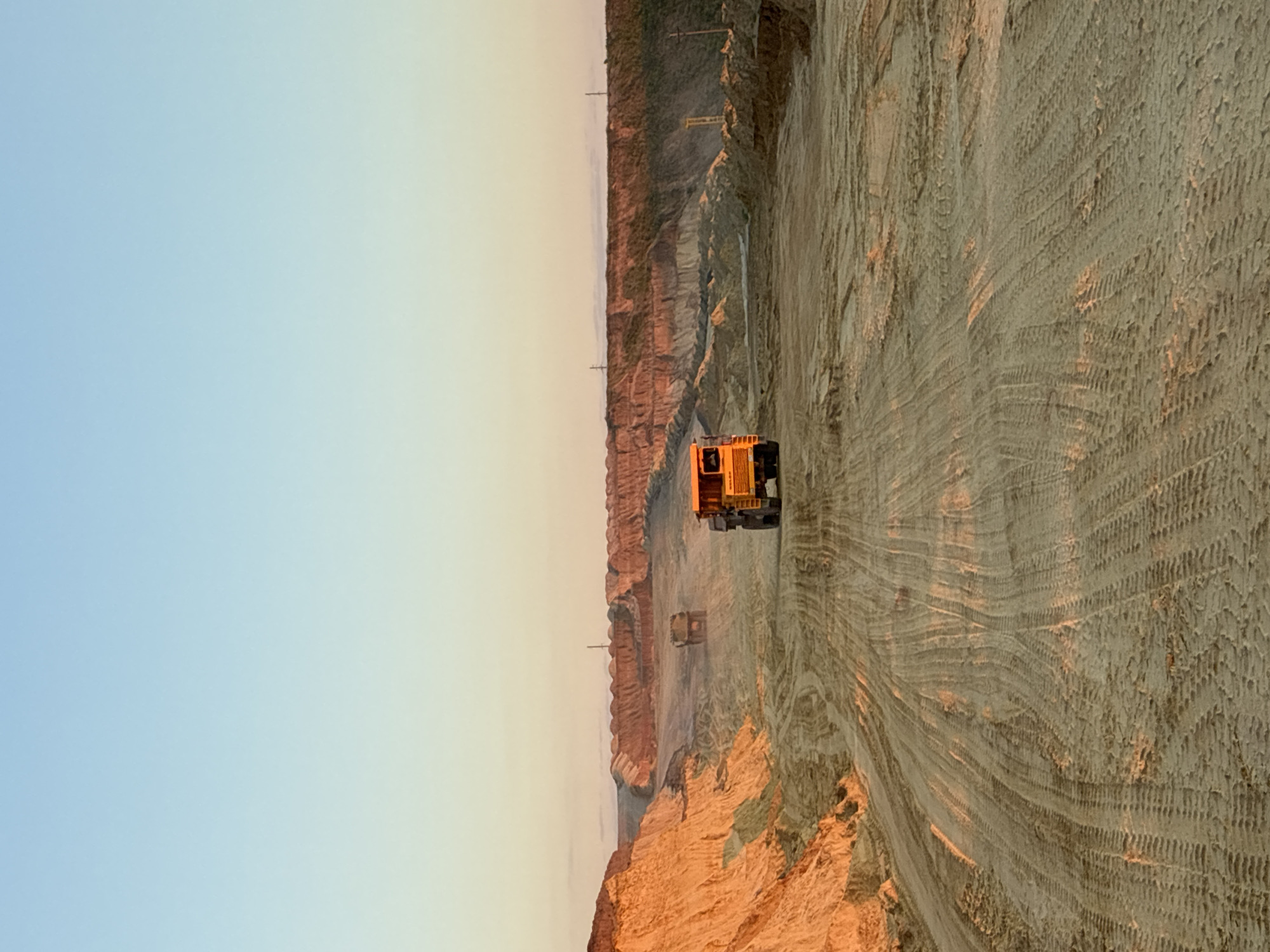 Excavator loads dump truck at Tatsinskaya quarry site
