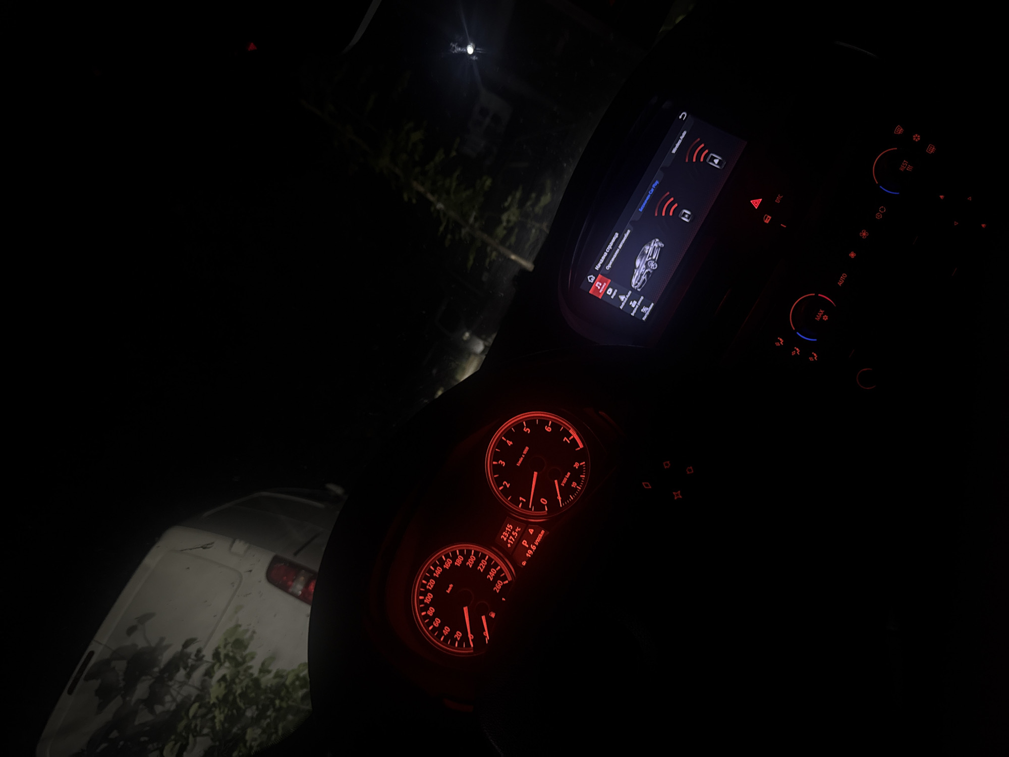 Driver documents illuminated car dashboard during nighttime journey in Bulgaria