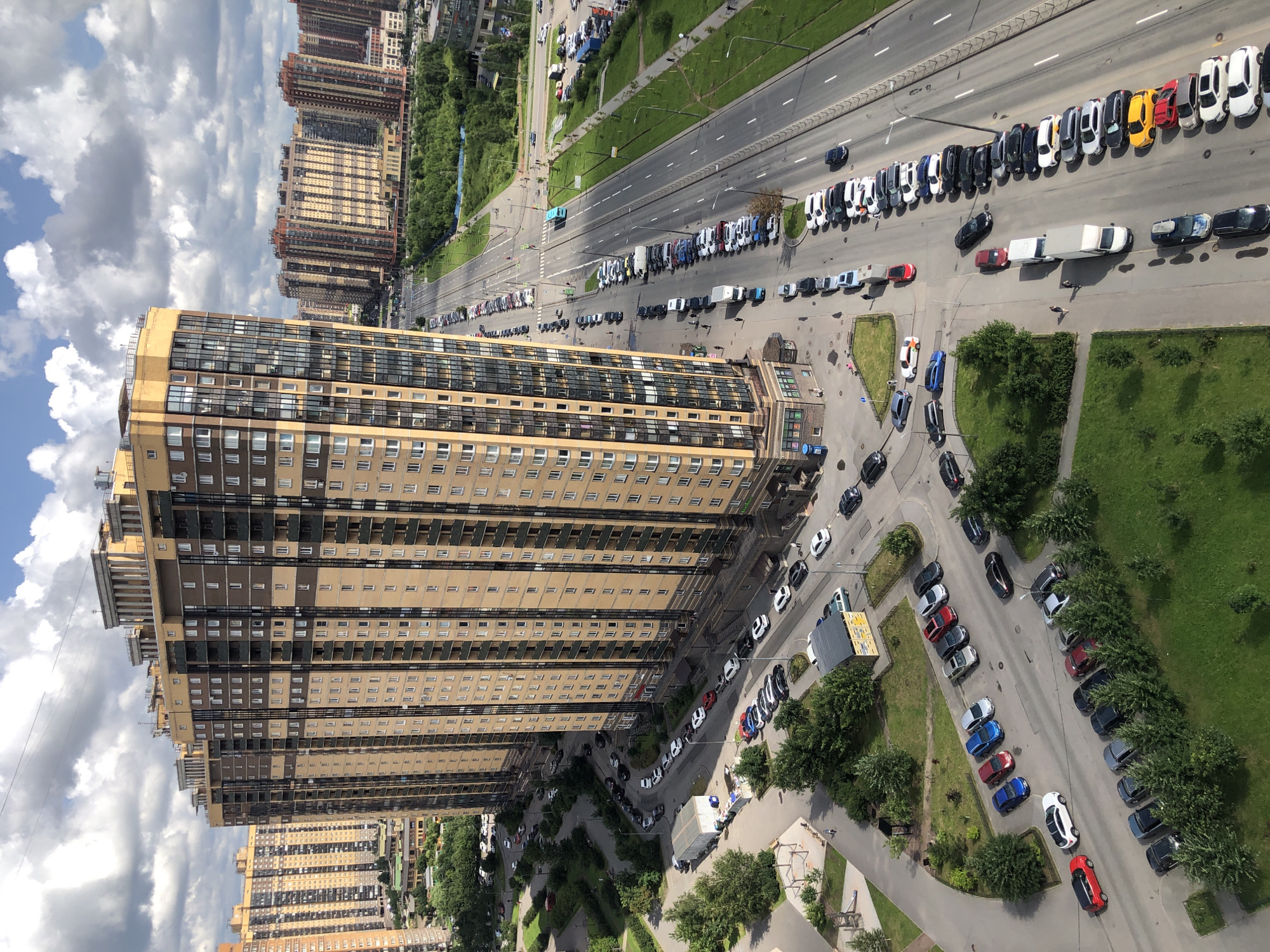 Aerial sweep of a dense apartment district, plus one window cat