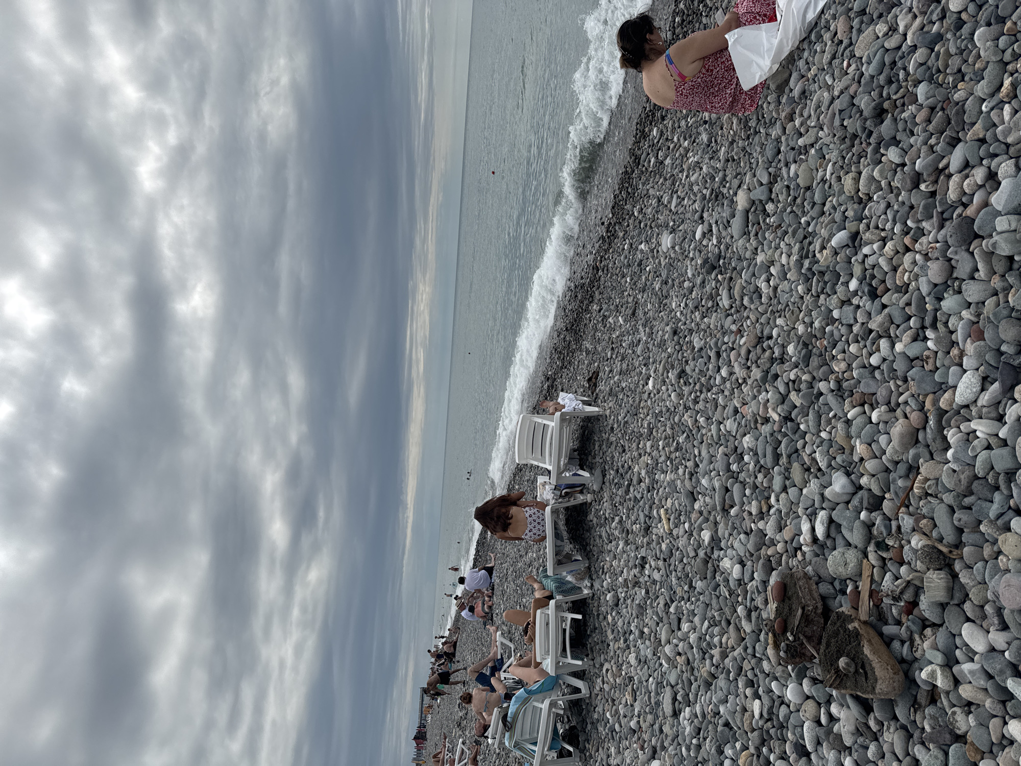 Overcast afternoon on Batumi's busy pebble beach