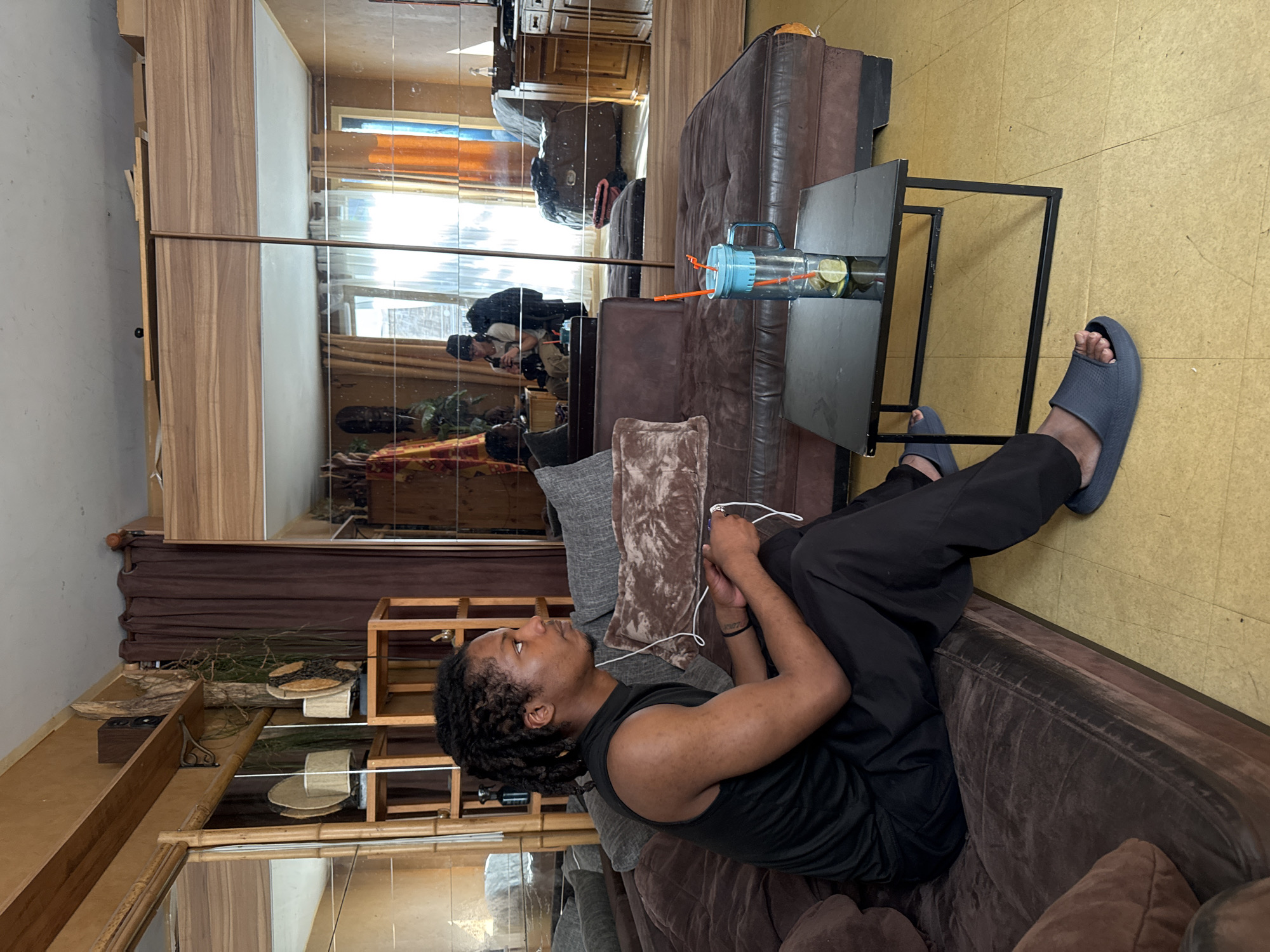 Man relaxes on sofa in sunlit Orsay interior
