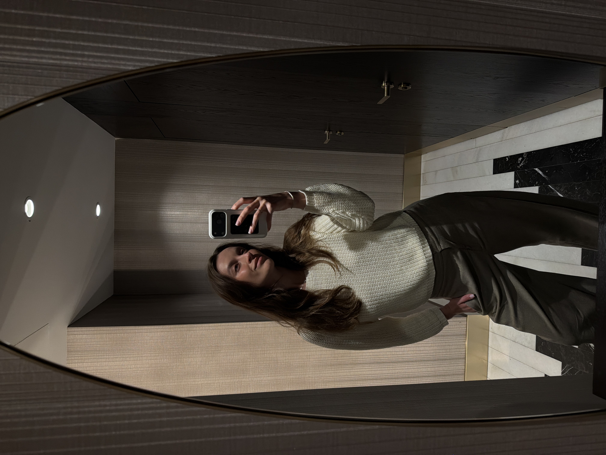 Woman takes mirror selfies in interior space, Budva
