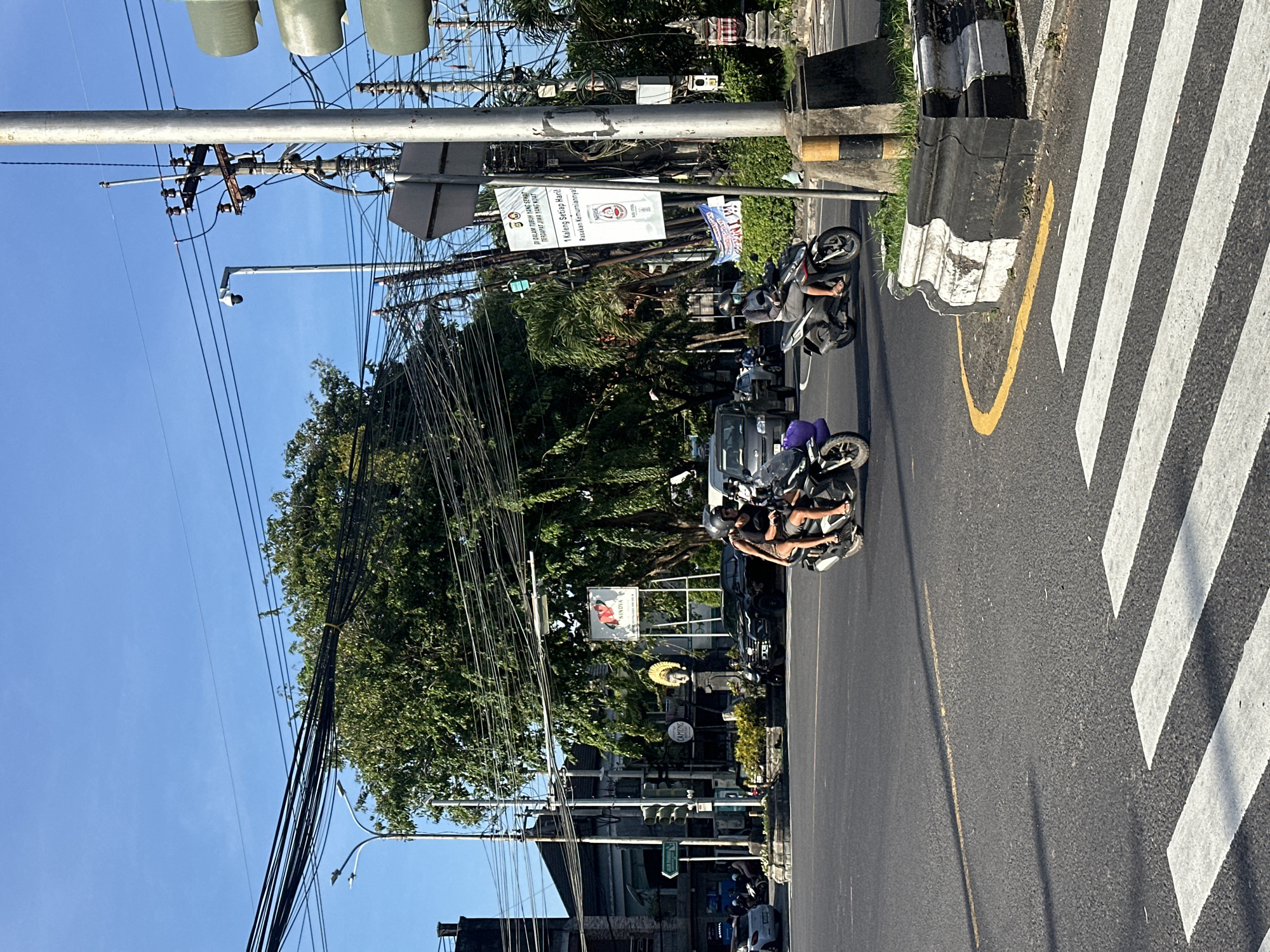 Couple documents motorcycle ride through busy Denpasar streets