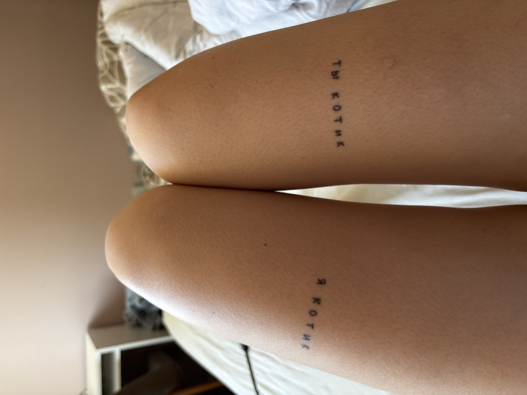 Person displays Cyrillic leg tattoos in Tbilisi