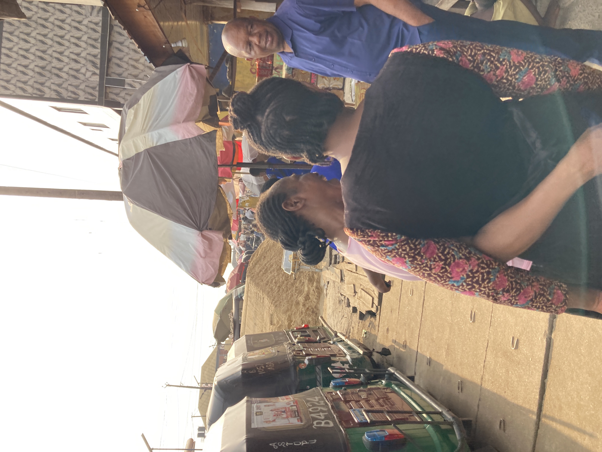 Auto rickshaws line busy Aba market scene