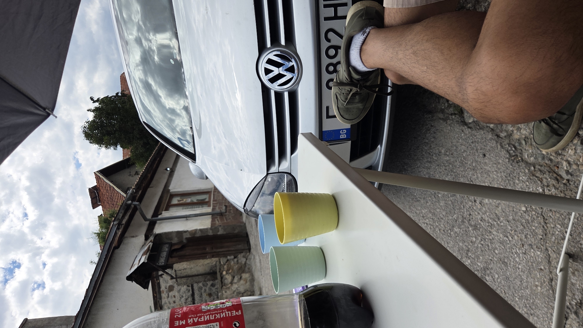 Multiple Volkswagens parked on a quiet Bania street, mid-activity