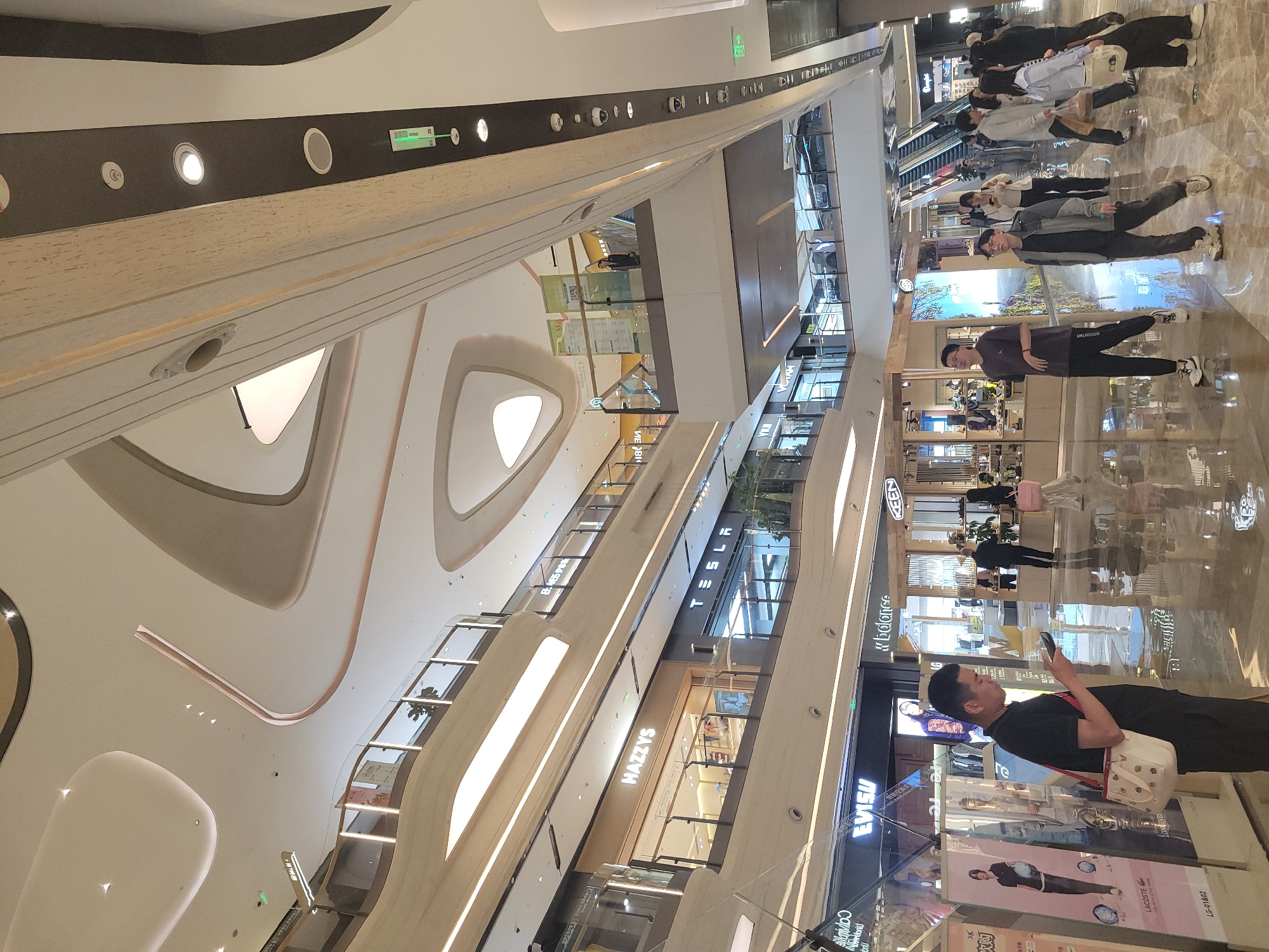 Shoppers browse multi-level mall in Liangjiang, China