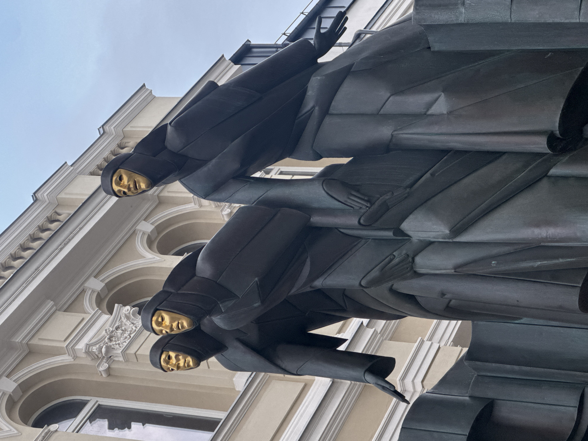 Bronze sculpture with golden faces spotted at Vilnius theatre