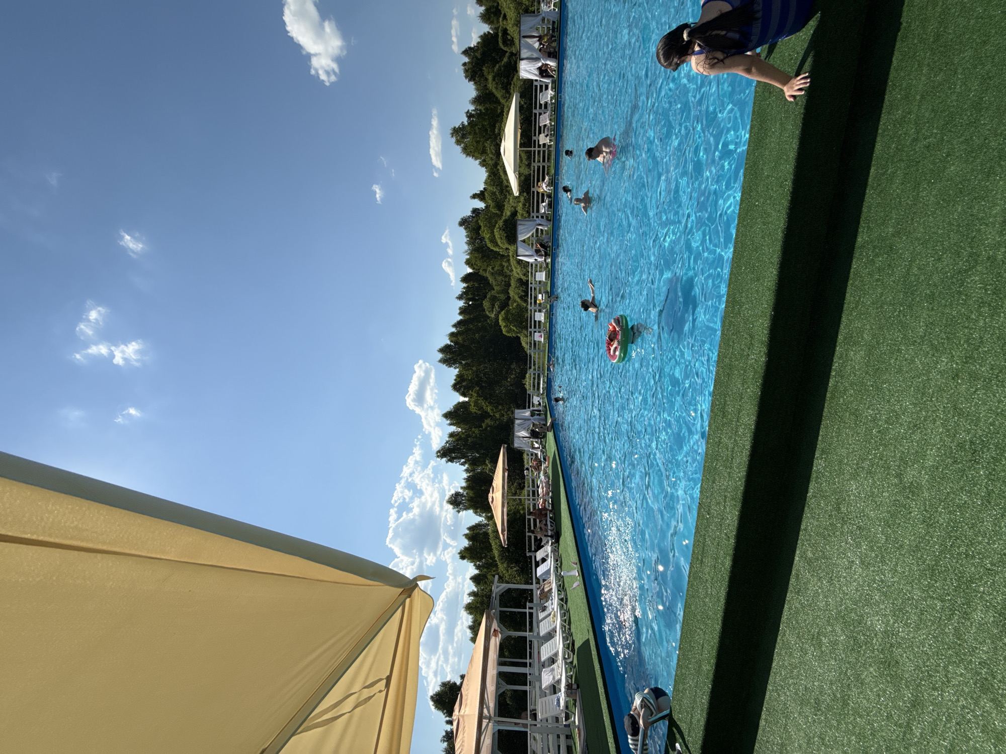 Child enjoys poolside time with smartphone in Koloksha, Russia