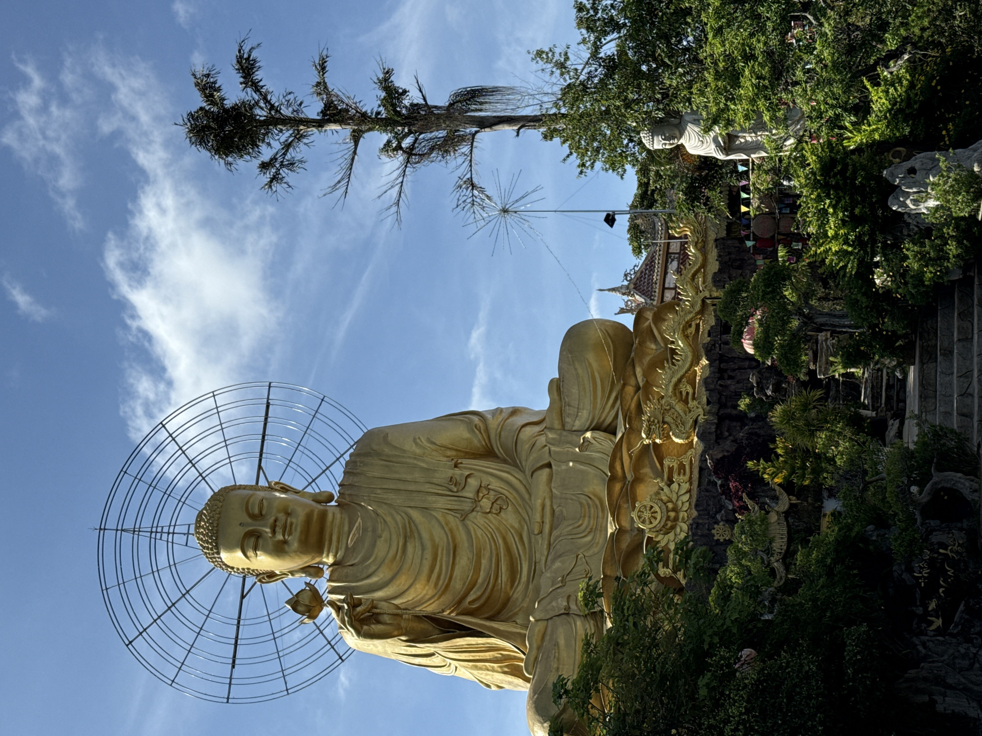 Temple visit documented in Đà Lạt featuring golden Buddha statue
