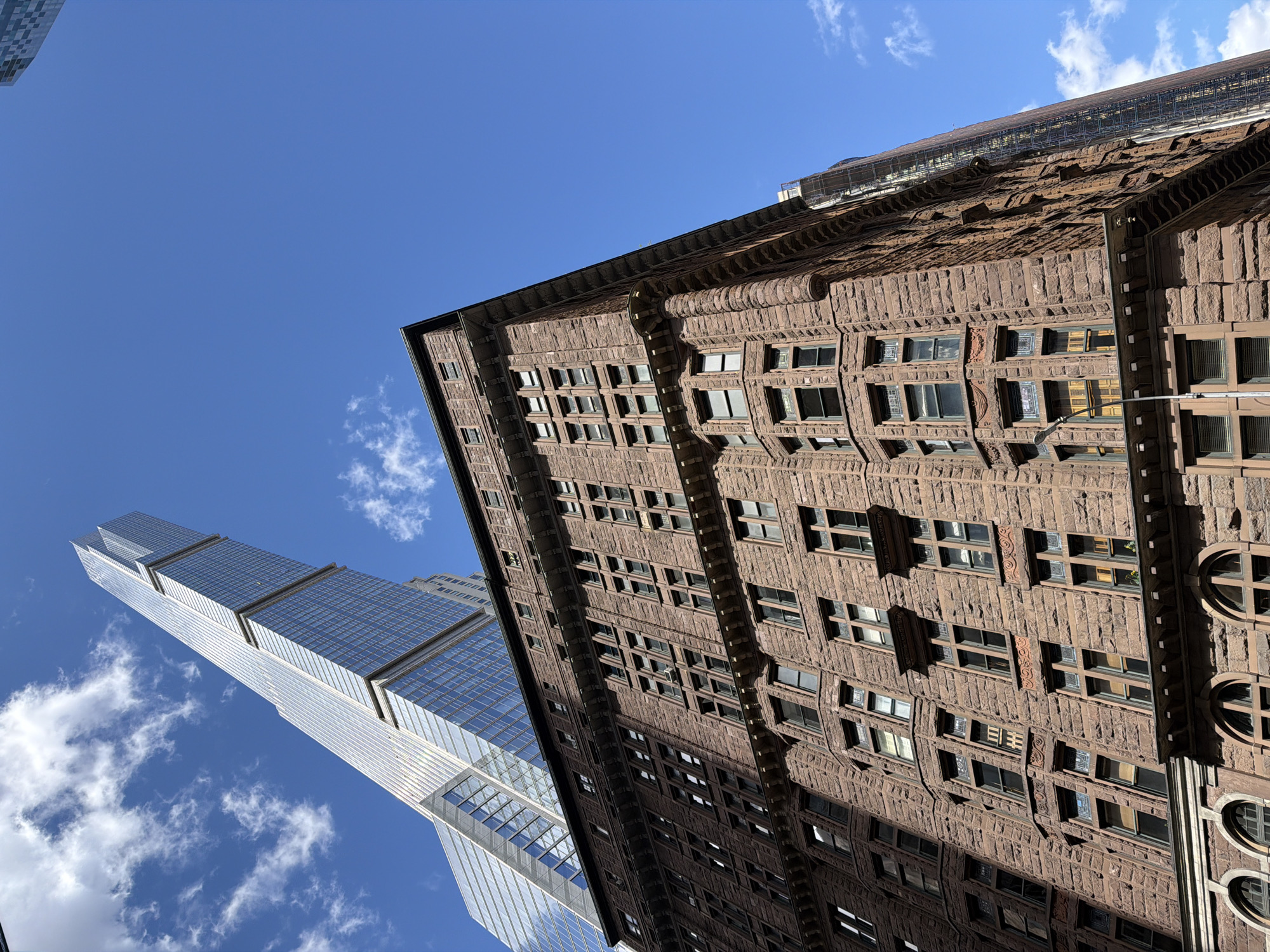 Street photographer captures Manhattan buildings on sunny afternoon