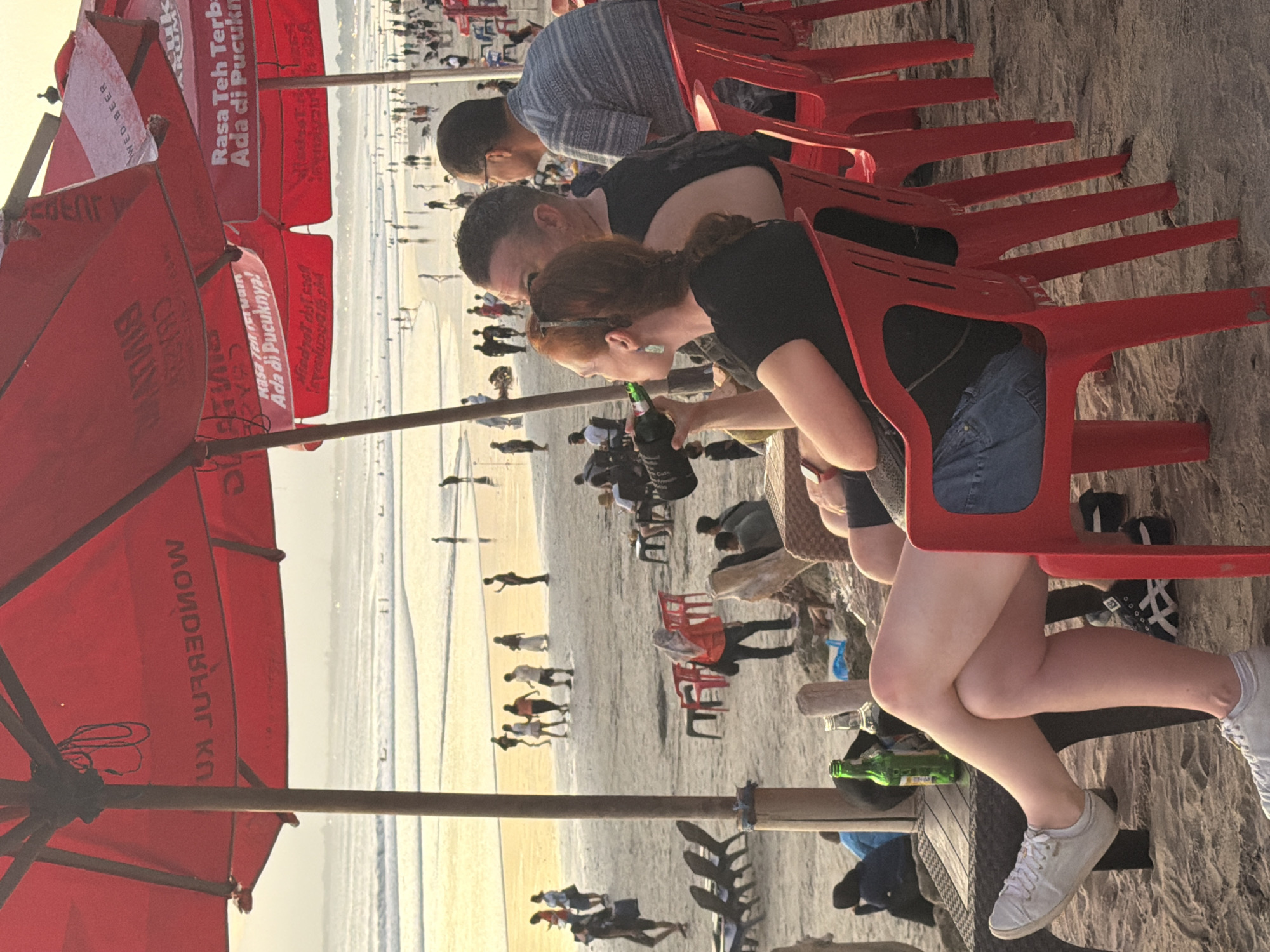Sunset hour on Kuta Beach, streets and shoreline both busy