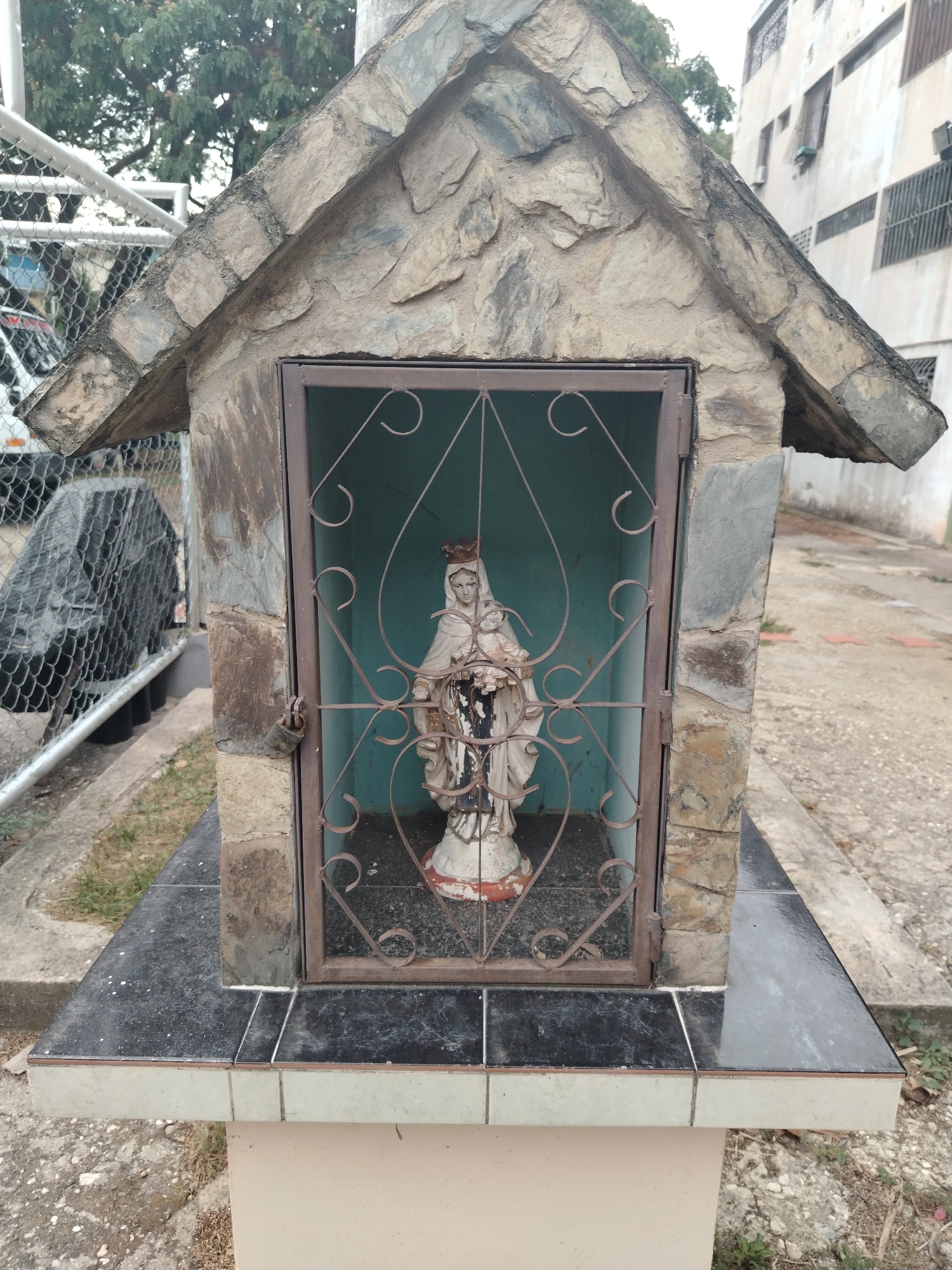 Stone shrine with metal gate observed in Tinaquillo, Venezuela