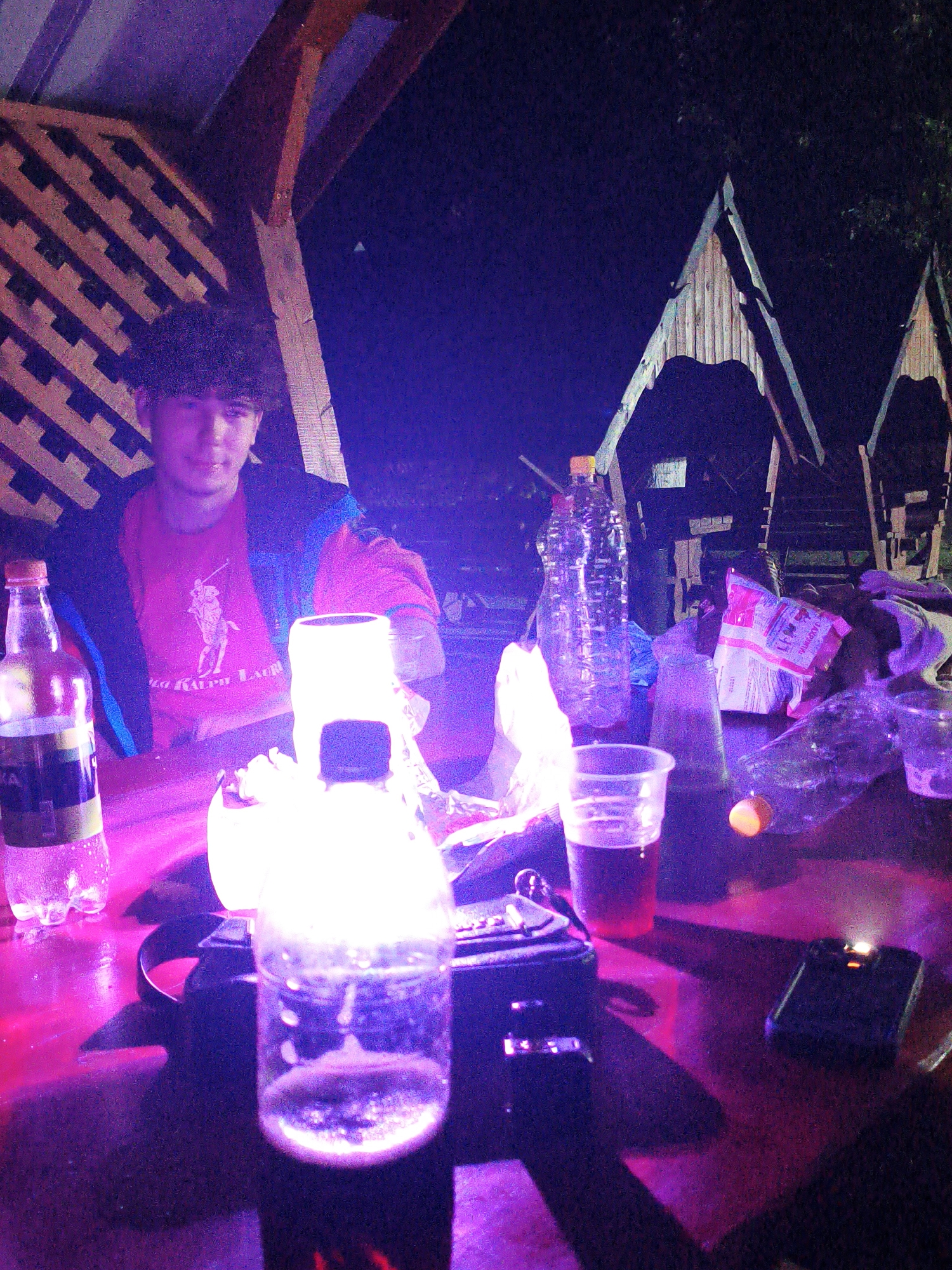 Late evening gathering at a lit gazebo in Ustyvytsia, Ukraine