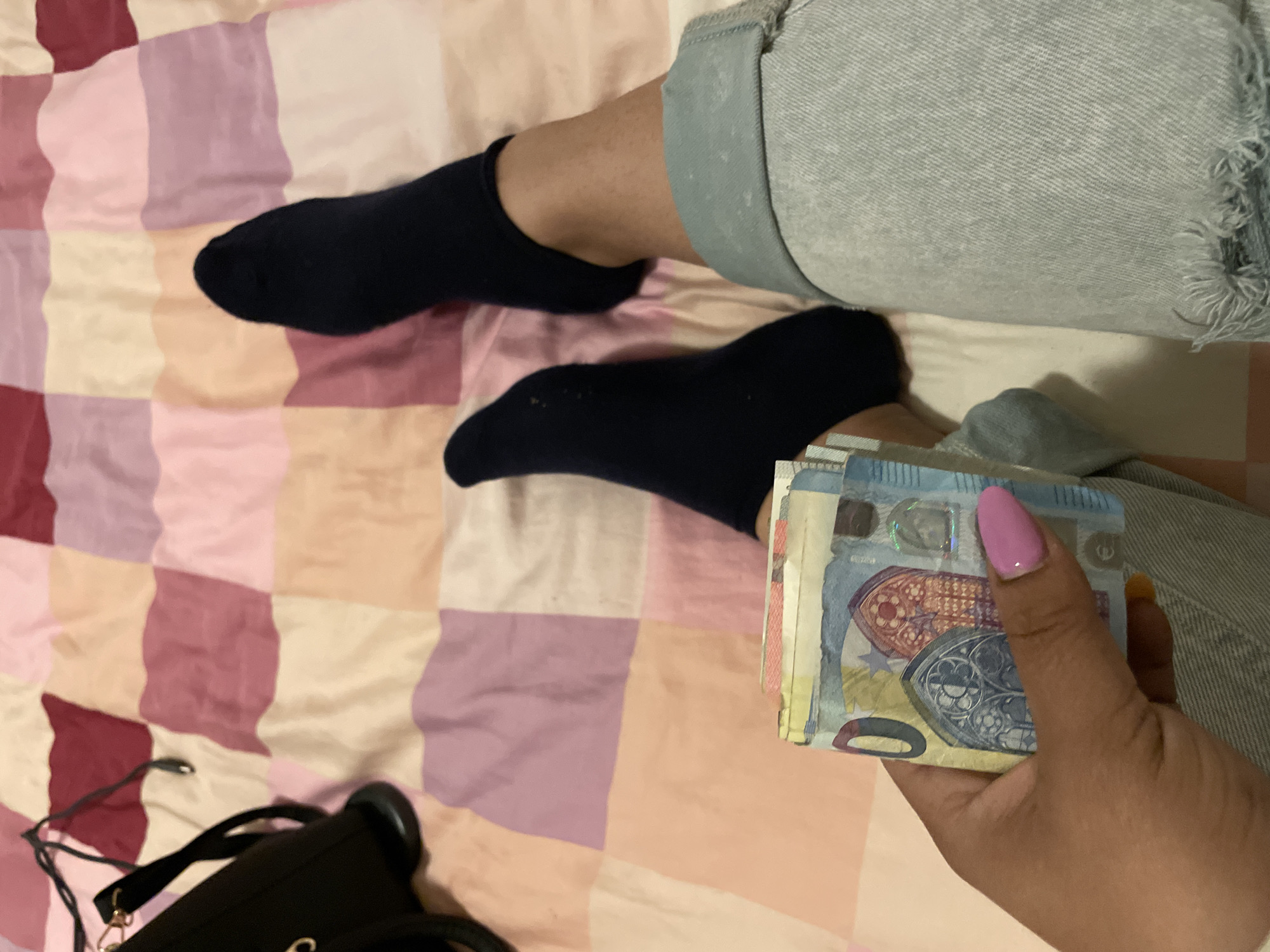 Person holds Euro cash on bed in Dronten