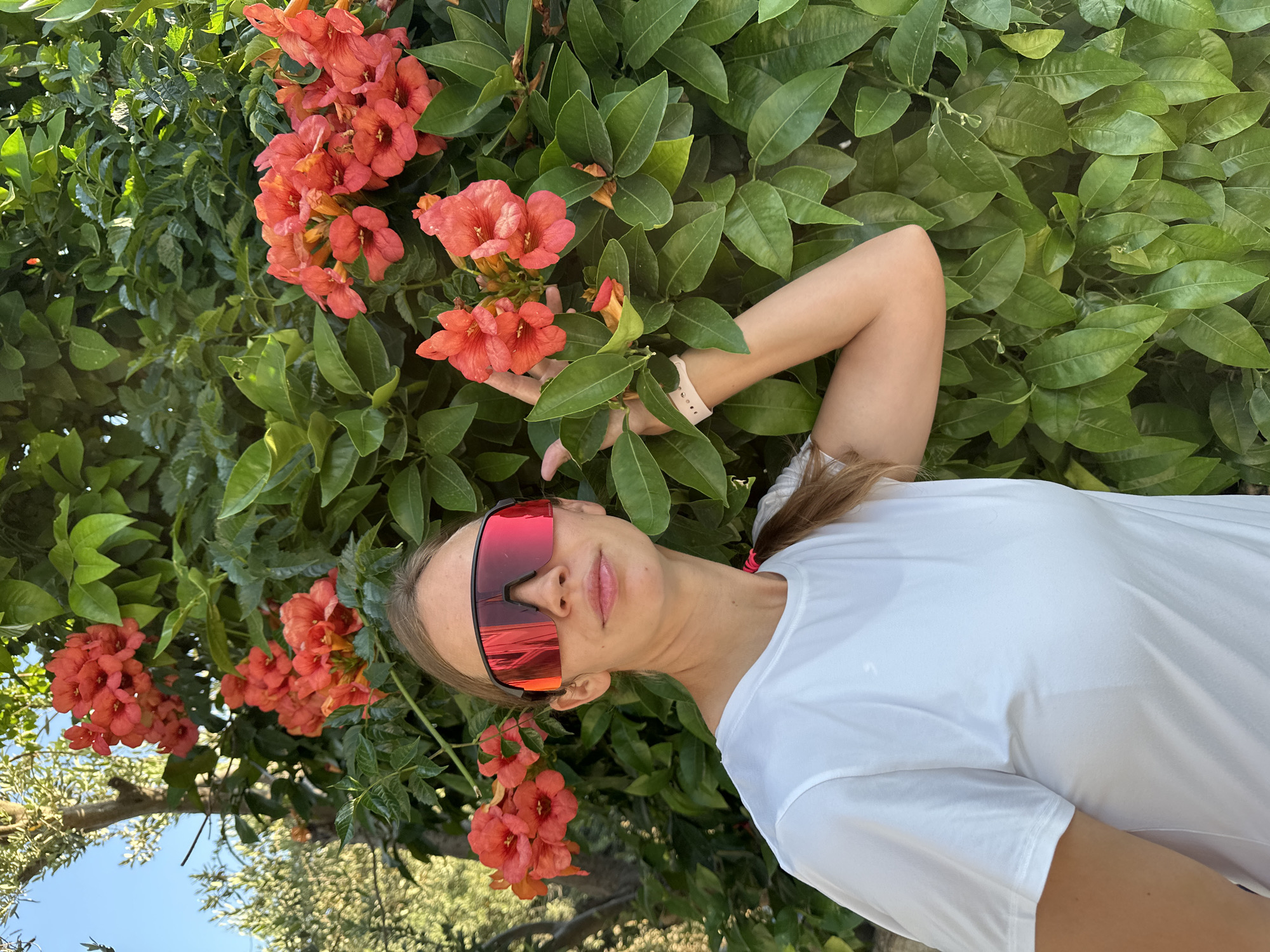 Woman waves under bougainvillea tree in Fethiye, Turkey