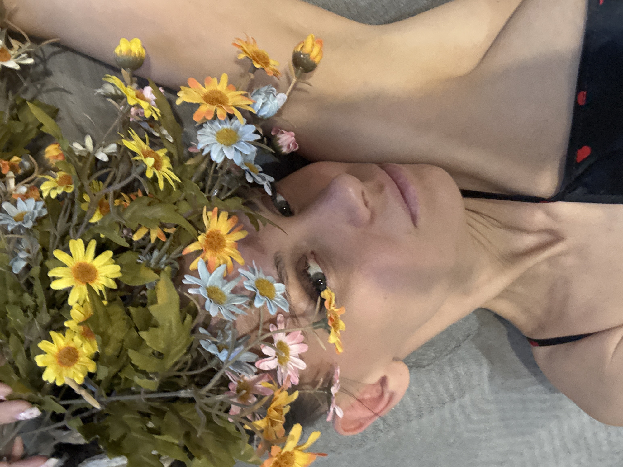 Woman photographed with flowers in braided hair, Yaroslavl'